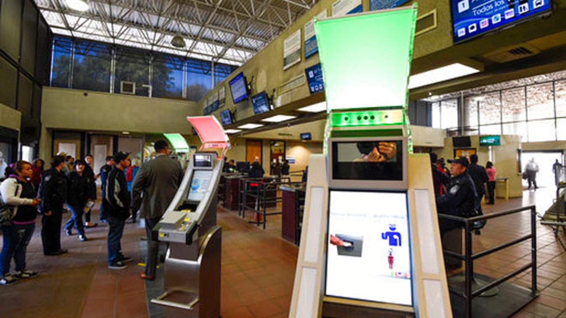Dec. 10, 2015: Pedestrians crossing from Mexico into the United States at the Otay Mesa Port of Entry wait to use biometric kiosks in San Diego