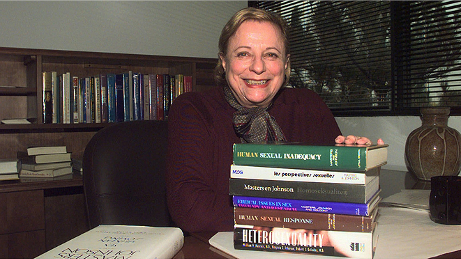 Nov. 7, 1997: Virginia Johnson Masters poses in her office at the Virginia Johnson Masters Learning Center in Creve Coeur, Mo., with some of the 19 publications that she has written or co-authored with her former husband and former partner Dr. William Masters. (AP/James A. Finley, File)
