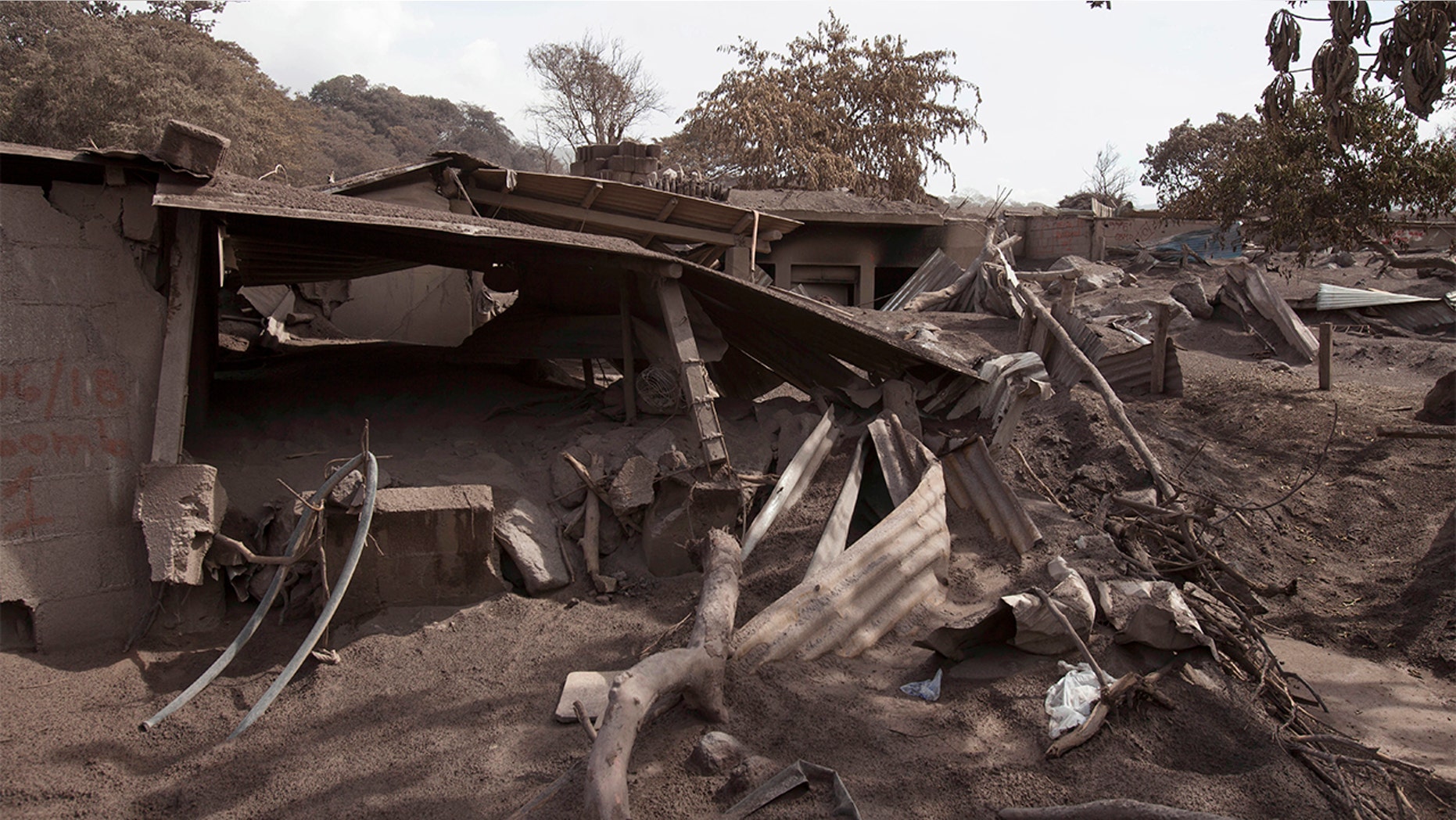 Volcanic ash blankets a home destroyed by the Volcan de Fuego, or "Volcano of Fire," eruption, in Escuintla, Guatemala.