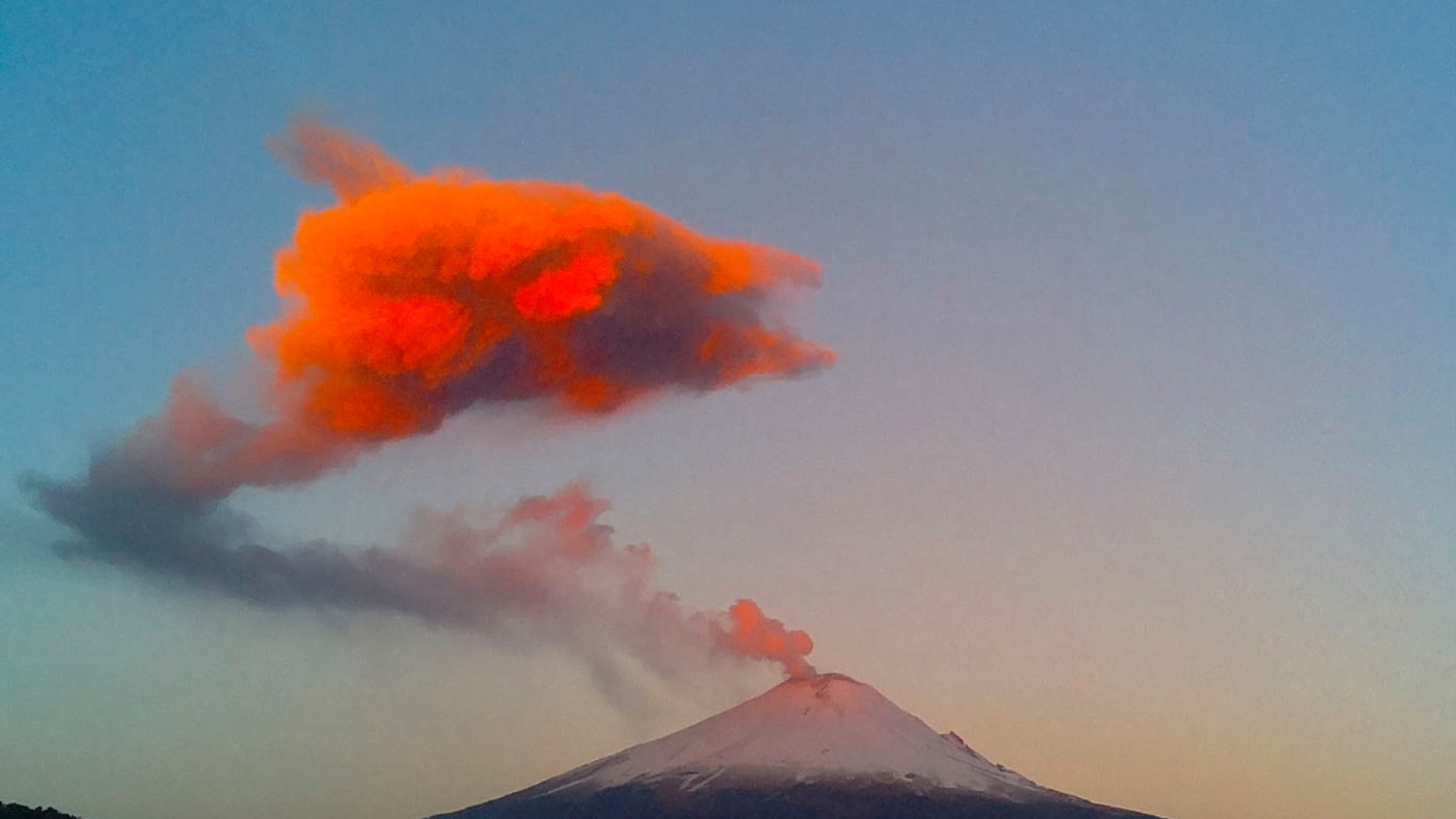 This March 25, 2015 file photo shows a plume of ash and steam rising from the crater of the Popocatepetl volcano, seen from the town of San Nicolas de los Ranchos, Mexico.