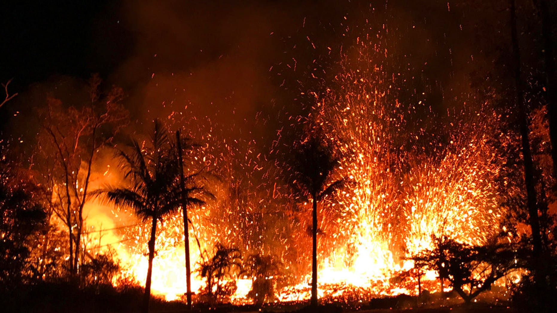 In this Saturday, May 5, 2018 photo, a new fissure erupts in Leilani Estates in Pahoa, Hawaii. Hawaii's erupting Kilauea volcano has destroyed homes and forced the evacuations of more than a thousand people. (U.S. Geological Survey via AP)