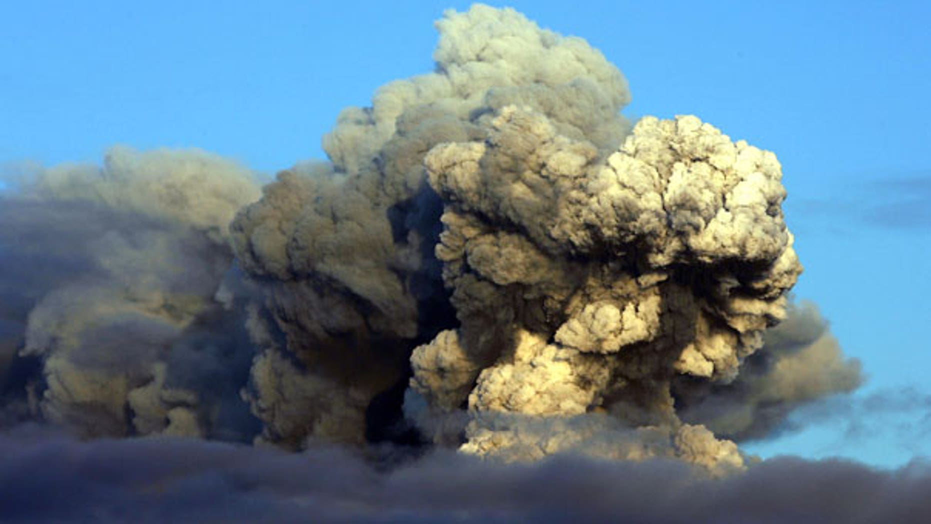 April 16: The volcano in southern Iceland's Eyjafjallajokull glacier sends ash into the air just prior to sunset. (AP)