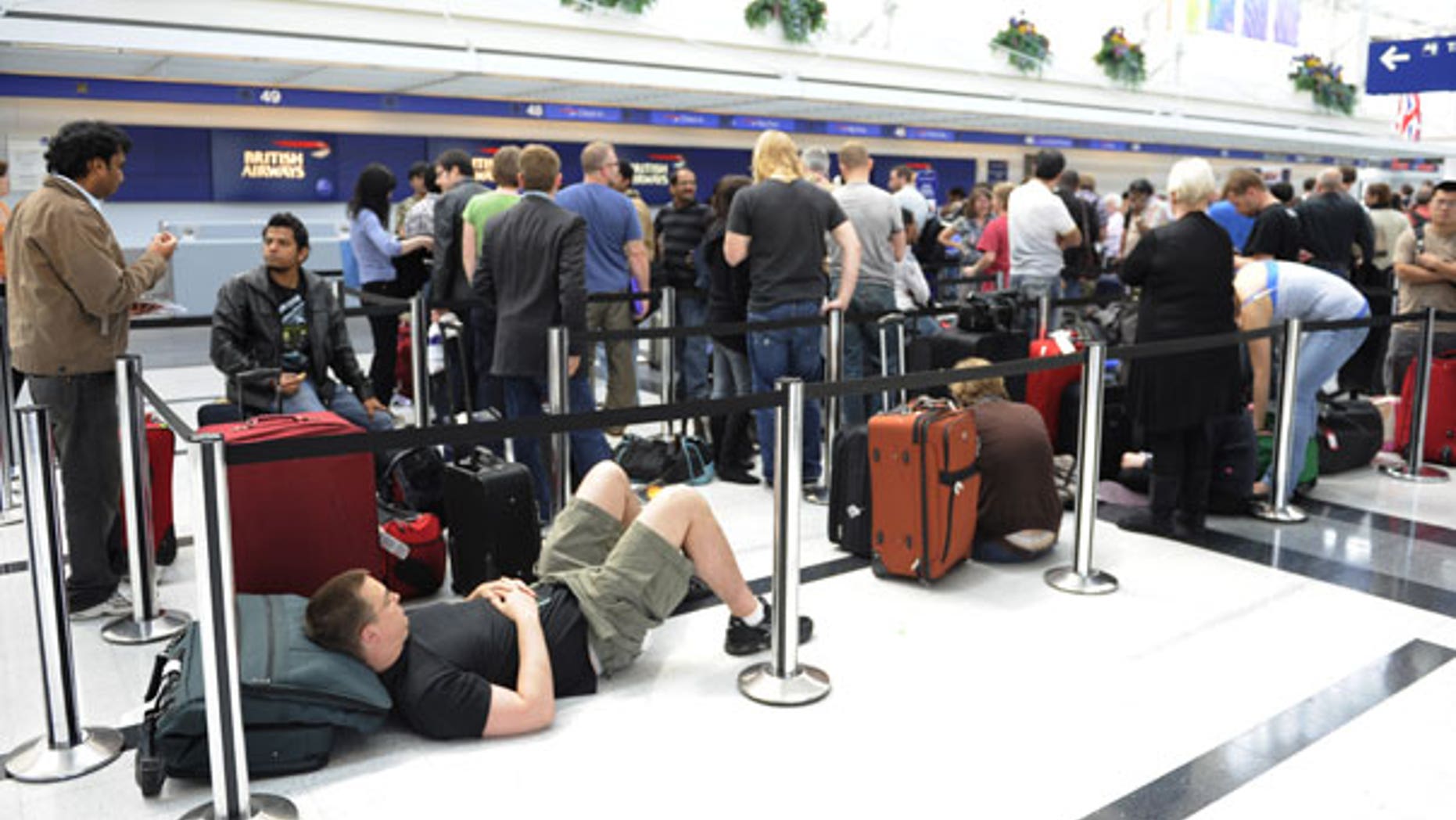 April 15: People wait in line at British Airways to try and catch flights to Europe at O'Hare International Airport in Chicago. (AP)