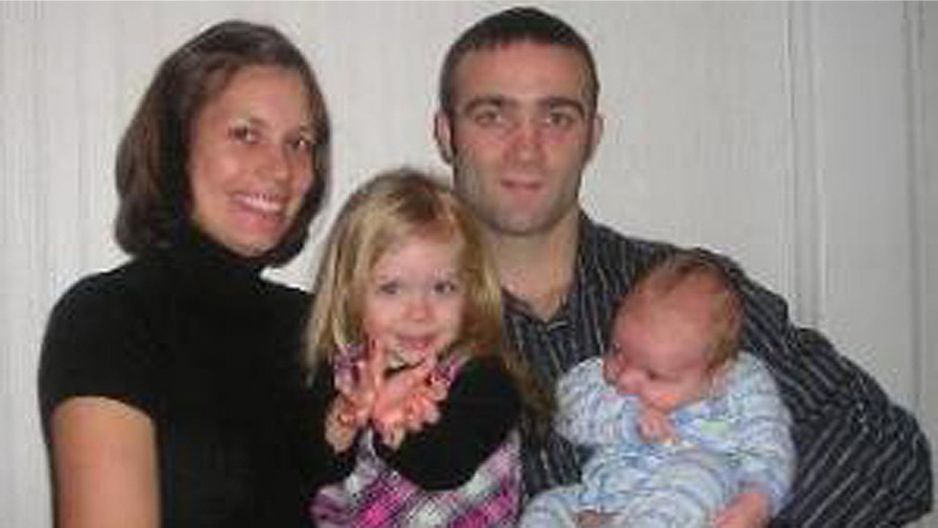 Jacob "Christmas" Volkmann, a lightweight UFC fighter, is seen here in an undated photograph with his family.