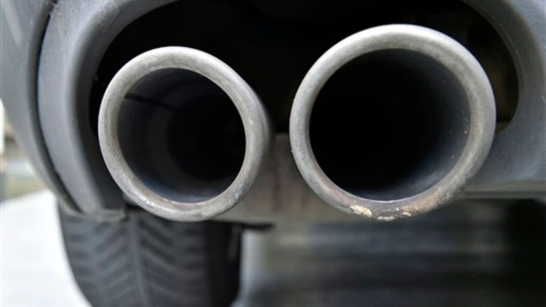 The exhaust pipes of an up to date Audi car blow out not visible emissions during the engine start in Gelsenkirchen, Germany, Wednesday, Nov. 4, 2015. Volkswagen said Tuesday that an internal investigation has revealed "unexplained inconsistencies" in the carbon dioxide emissions from 800,000 of its vehicles. (AP Photo/Martin Meissner)