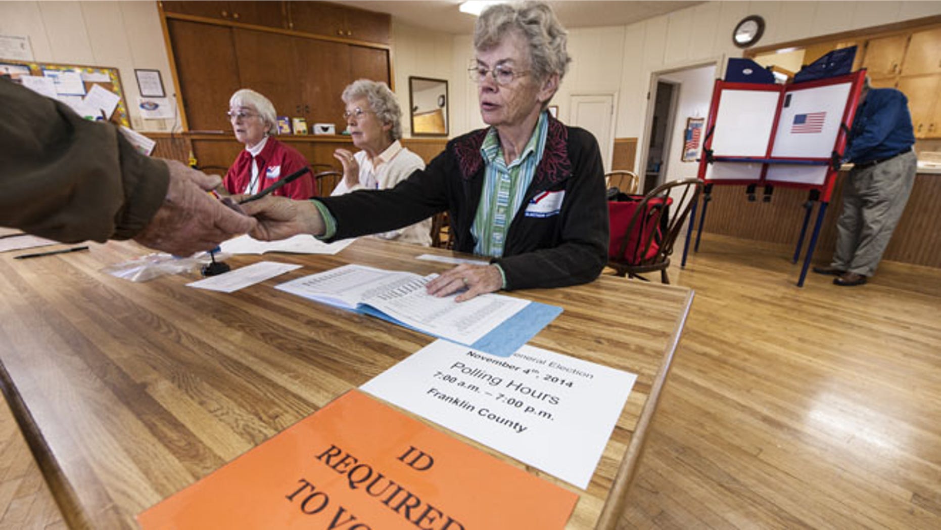 CENTROPOLIS TOWNSHIP, KS - NOVEMBER 4: Election worker Karen Witham checks voter identifications in the Richter Church November 4, 2014 in Centropolis Township, near Ottawa, Kansas. A tight race between independent candidate, Greg Orman (I-KS) and U.S. Sen. Pat Roberts (R-KS) brought voters to the polls in the Kansas midterm elections. (Photo by Julie Denesha/Getty Images)