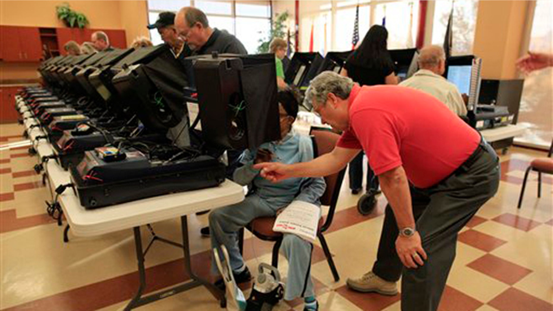 Voters take part in early voting at the Sun City Aliante Community Center Oct. 25 in Las Vegas. (AP Photo)