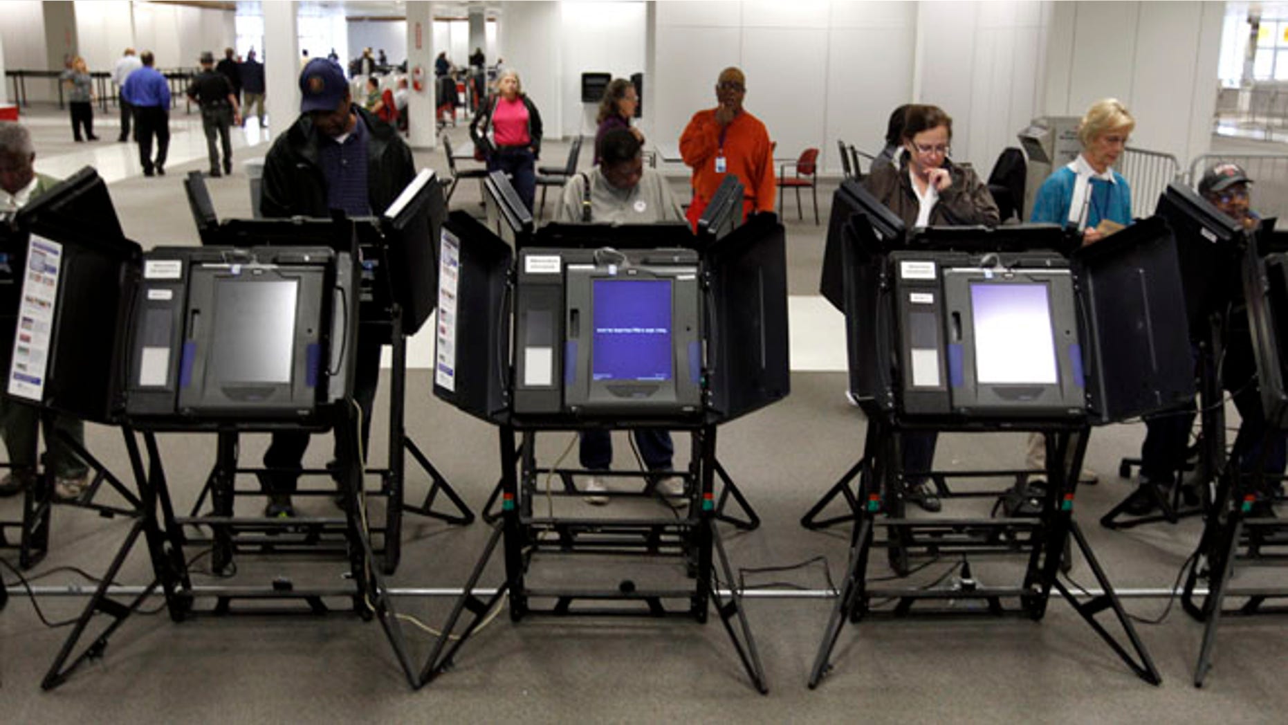 Oct. 2, 2012: Voters cast their ballots at a Franklin County polling location on the first day of in-person absentee voting in Columbus, Ohio.