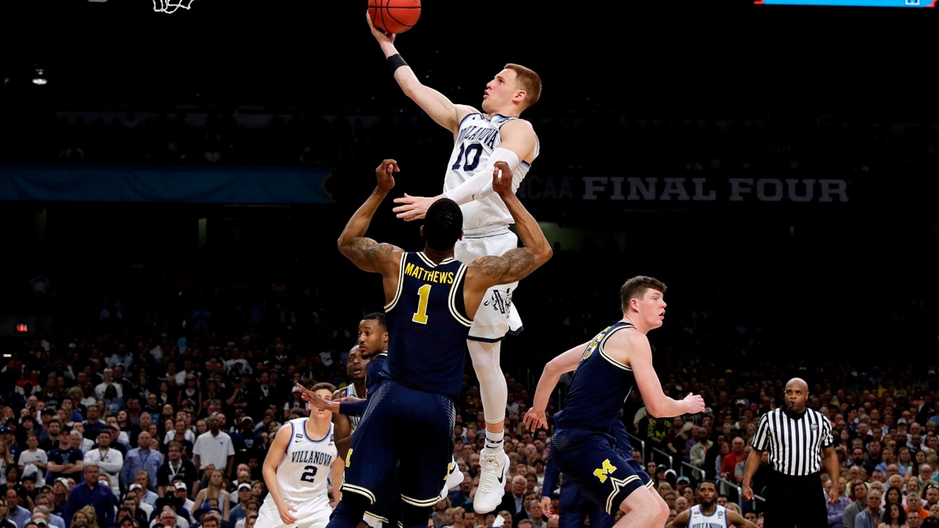Villanova guard Donte DiVincenzo drives to the basket over Michigan guard Charles Matthews (1) during the second half in the championship game of the Final Four NCAA college basketball tournament, Monday, April 2, 2018, in San Antonio. (AP Photo/David J. Phillip)