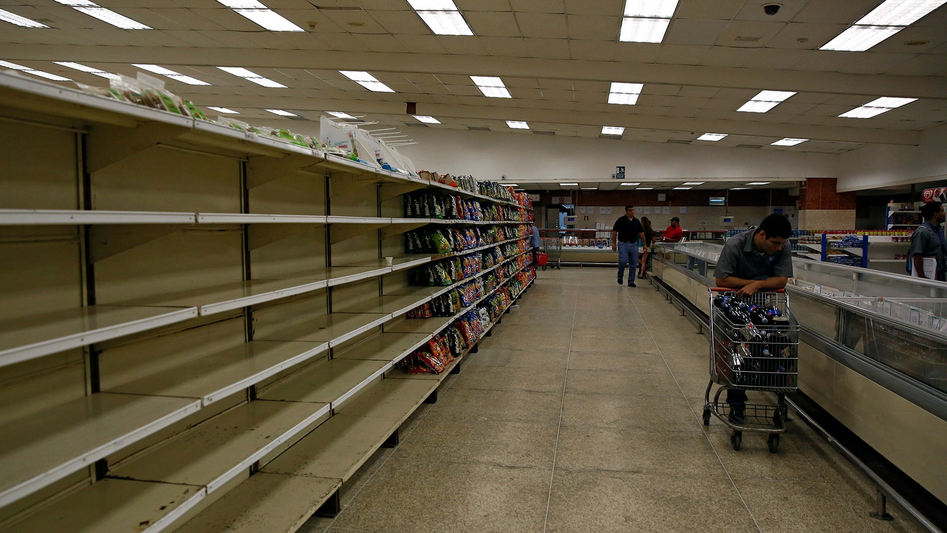 People buy food and other staple goods inside a supermarket in Caracas, Venezuela June 30, 2016.