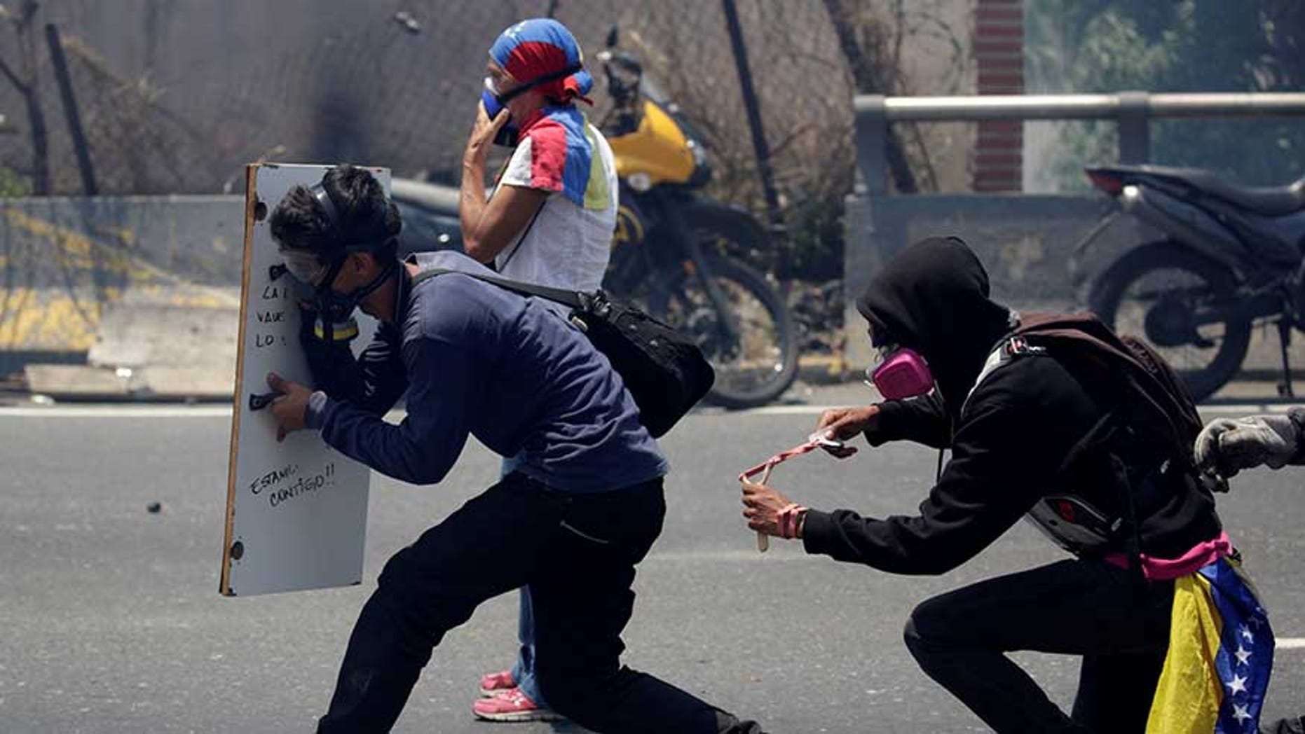 Opposition supporters clash with security forces during a rally in Caracas, Venezuela, April 26, 2017.