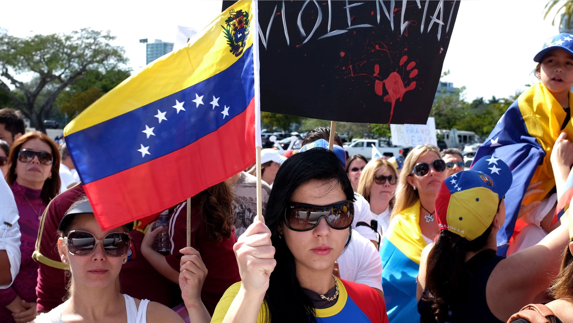 MIAMI, FL - MARCH 01: Dela Pozo (C) and other Venezuelans and their supporters show their support for the anti-government protests in Venezuela on March 1, 2014 in Miami, Florida. In Venezuela, protests over the past couple of weeks have resulted in violence as government opponents and supporters have faced off in the streets. (Photo by Joe Raedle/Getty Images)