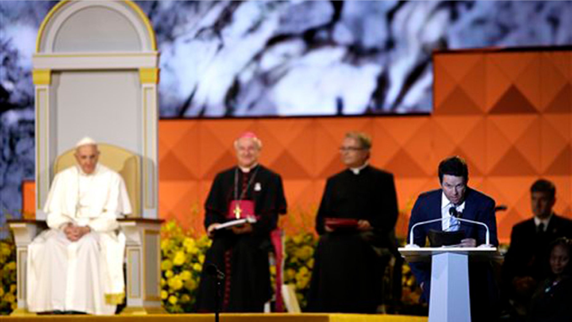 Sept. 26, 2015: Actor Mark Wahlberg speaks as Pope Francis is seated nearby during the Festival of Families in Philadelphia.