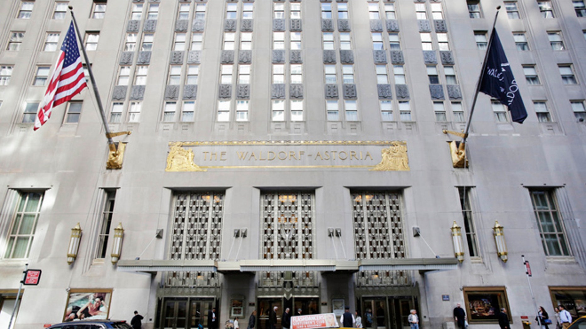 In this Oct. 6, 2014 file photo, a taxi passes in front of the Waldorf Astoria hotel in New York.