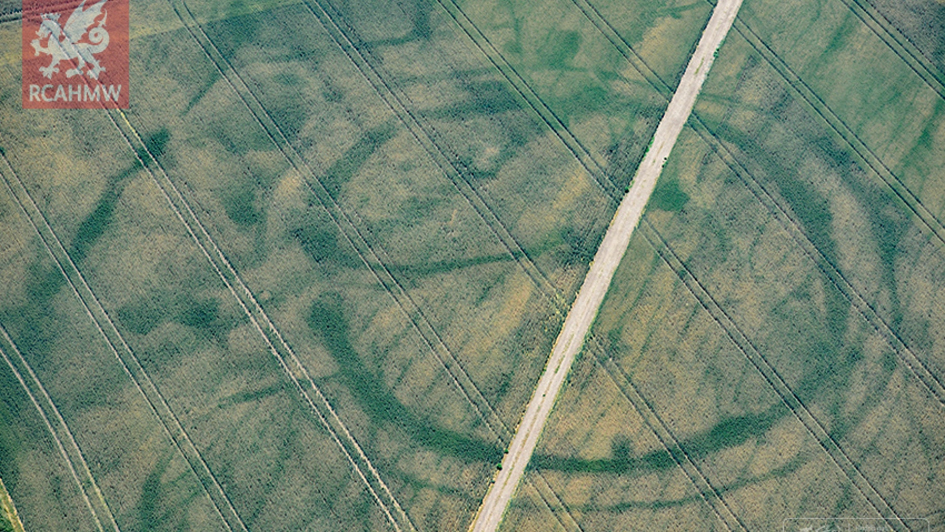Cropmarks of a large prehistoric enclosure in Wales' Vale of Glamorgan, with the faint footings of a probable Roman villa within (Crown Copyright RCAHMW)