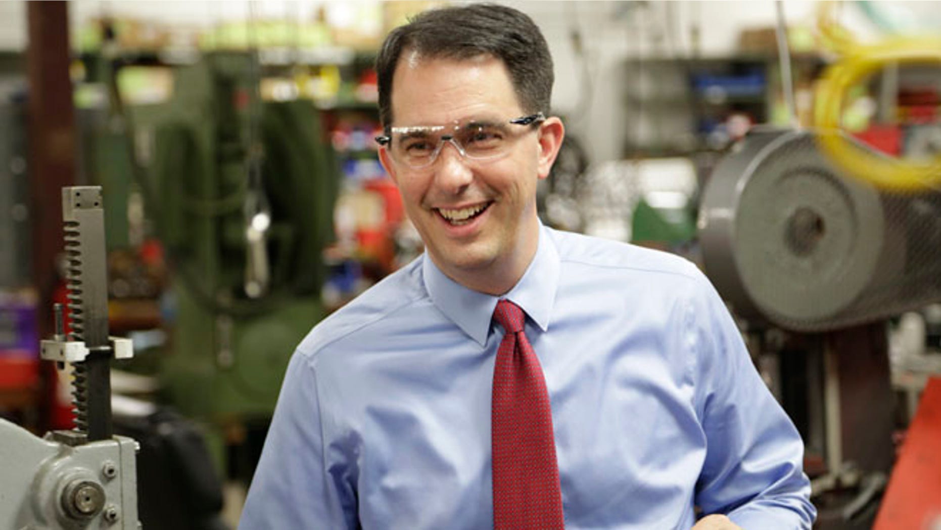 Sept. 23, 2014: Wisconsin Repubican Gov. Scott Walker makes a re-election campaign stop at a small business in Racine, Wis.