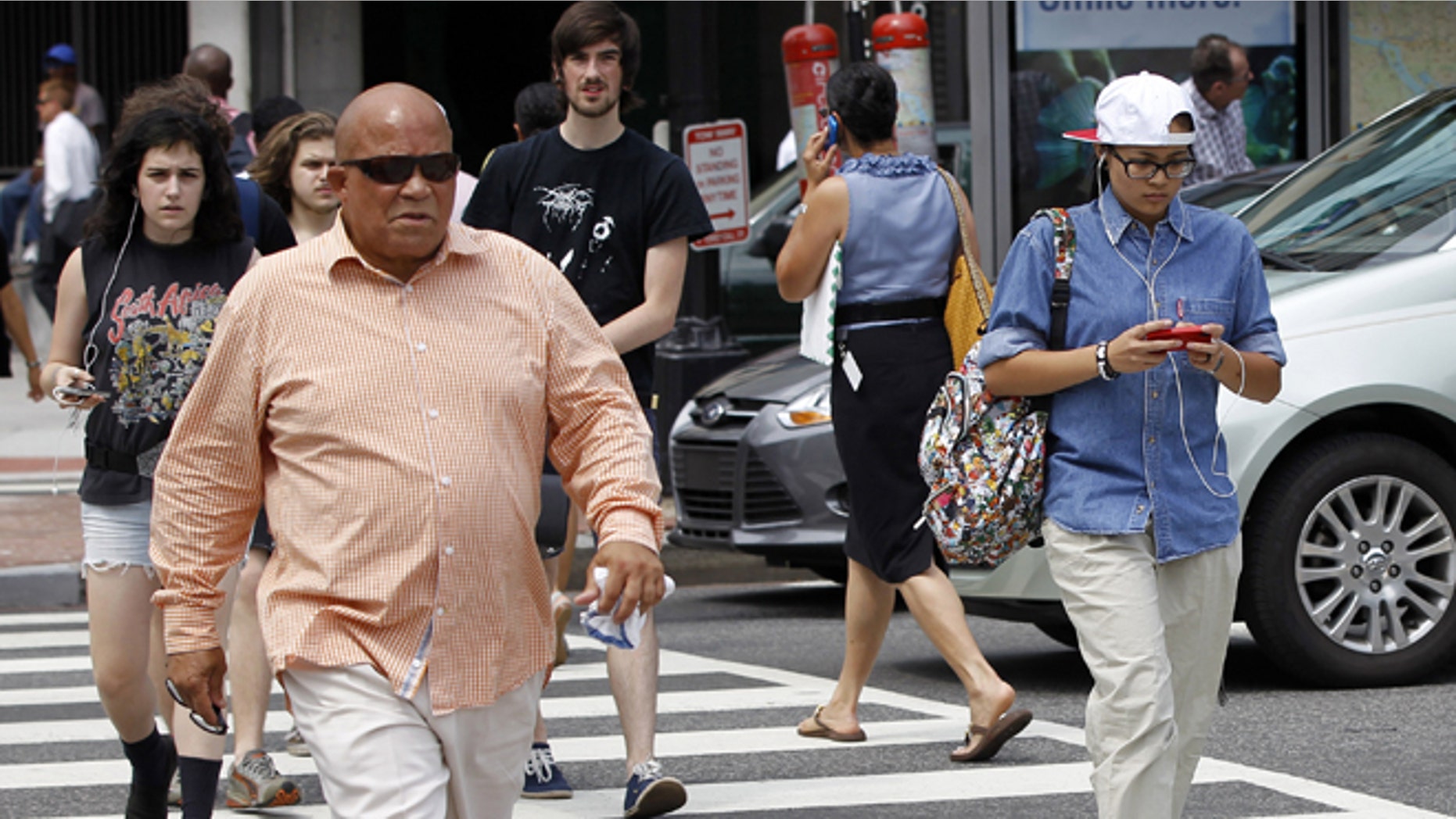 July 10, 2012: In this photo, pedestrians cross K Street and Connecticut Ave. NW near the Farragut North Metro Entrance in downtown Washington.