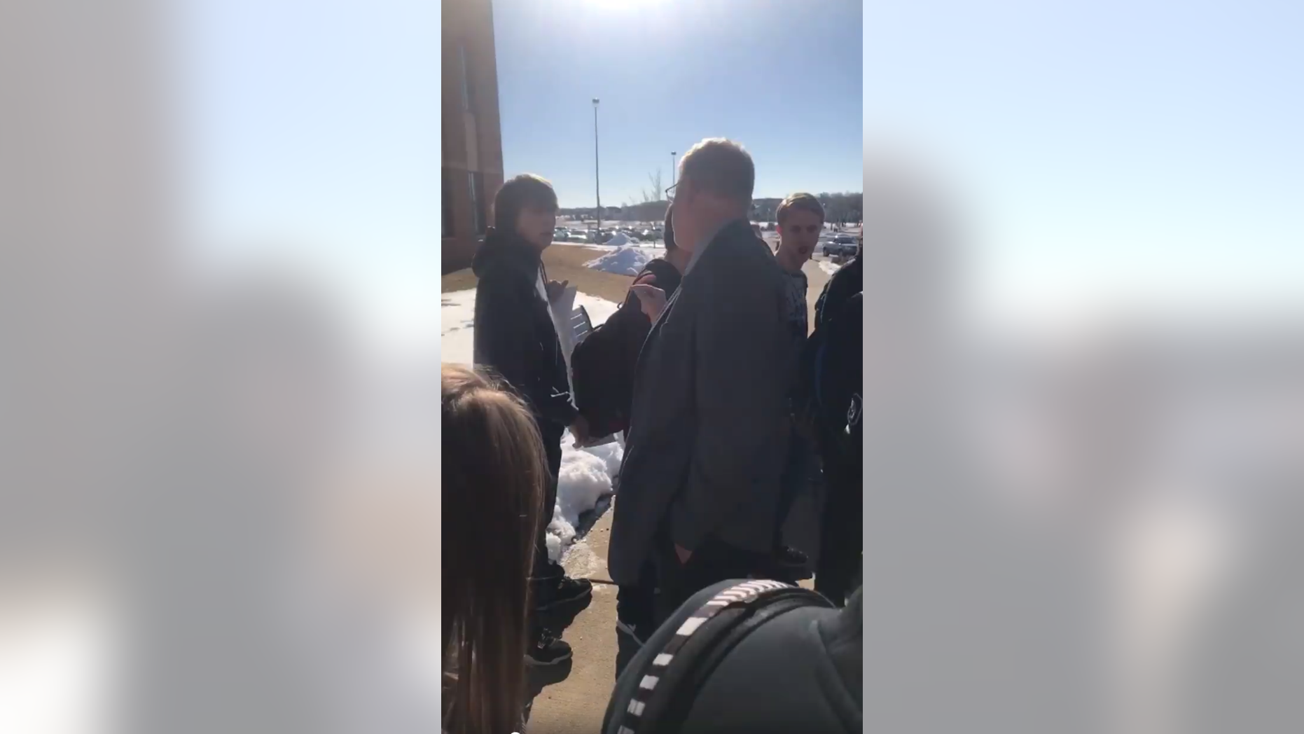 School Principal Lonnie Seifert is seen approaching a student carrying a pro-Second Amendment sign.