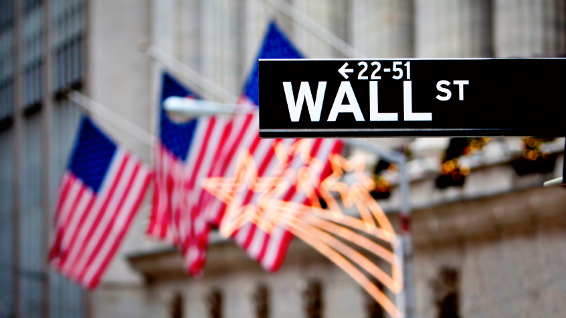 Wall street sign in New York with New York Stock Exchange background