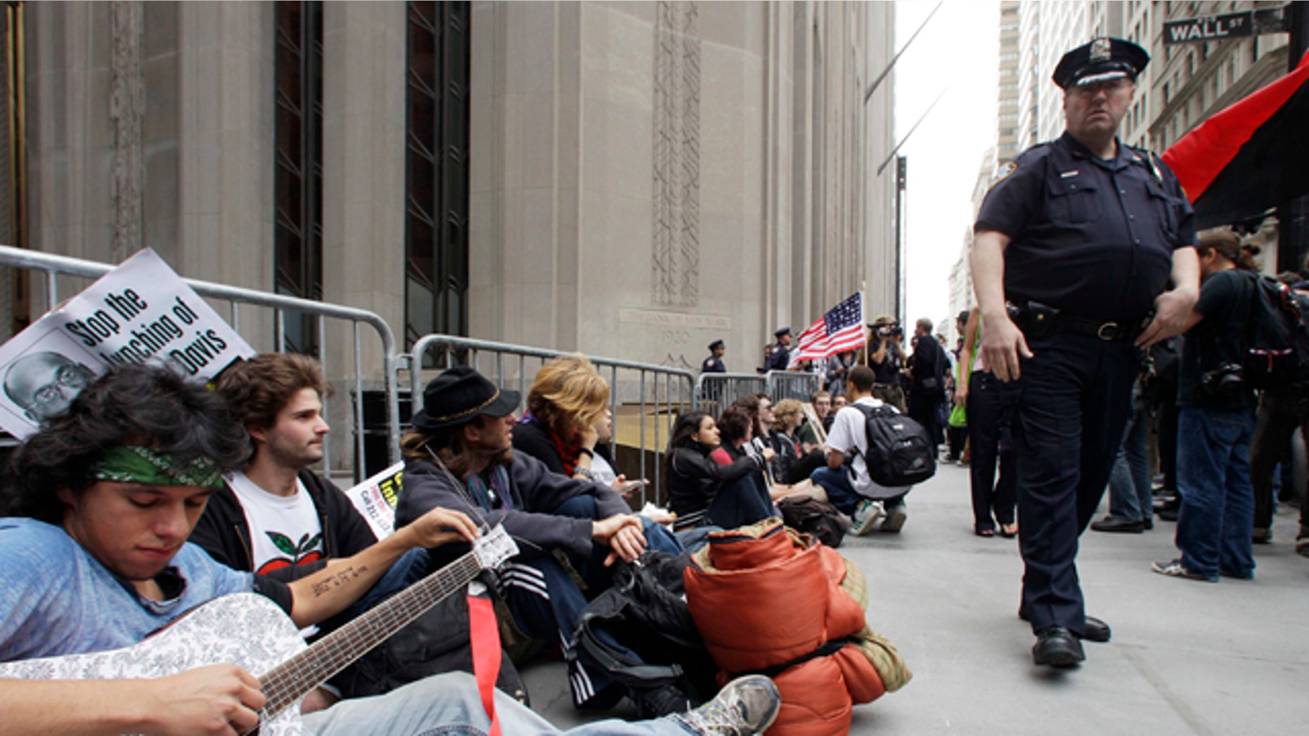 Sept. 17: Demonstrators gather in front of a police barricade to call for the occupation of Wall Street in New York.