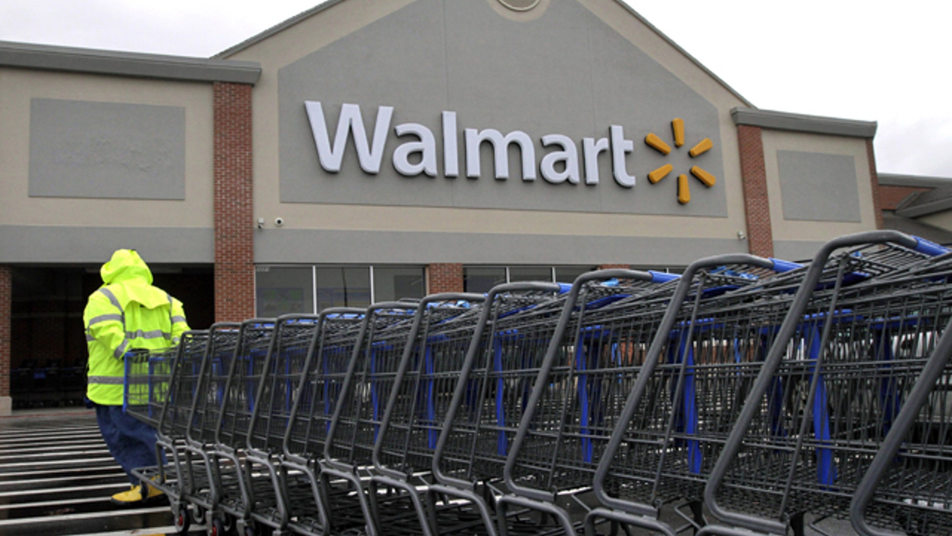 Nov. 13, 2012: A worker pulls a line of shopping carts toward a Walmart store in North Kingstown, R.I. (AP)