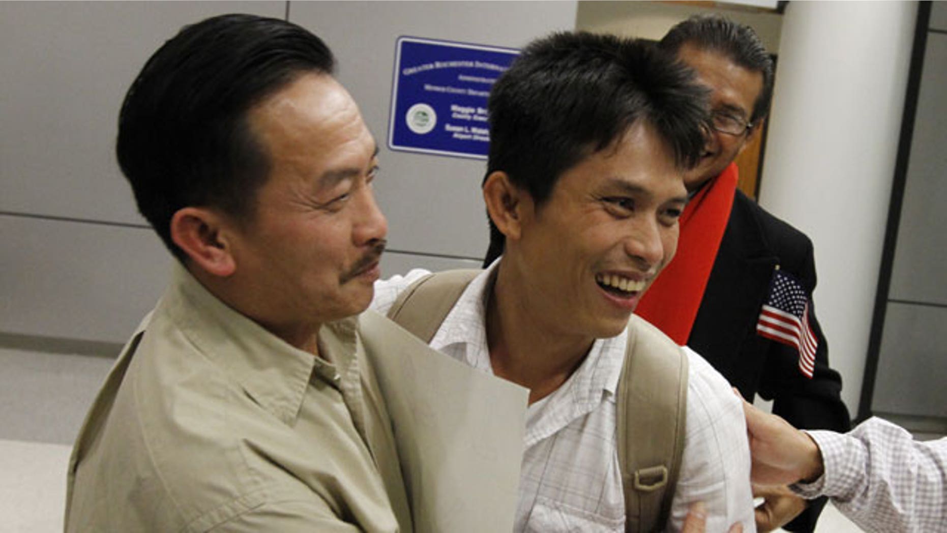 November 21, 2011: Hao Truong, Henrietta, left, embraces his son, Samart Khumkhaw, 34, during his emotion filled arrival at the Greater Rochester International Airport in Chili, N.Y.