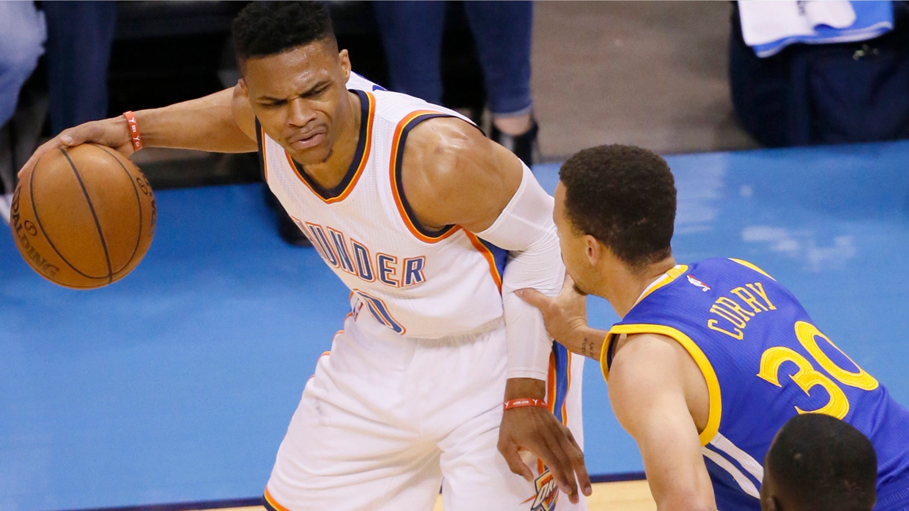 Oklahoma City Thunder guard Russell Westbrook (0) is defended by Golden State Warriors guard Stephen Curry (30) during the first half in Game 4 of the NBA basketball Western Conference finals in Oklahoma City, Tuesday, May 24, 2016. (AP Photo/Sue Ogrocki)
