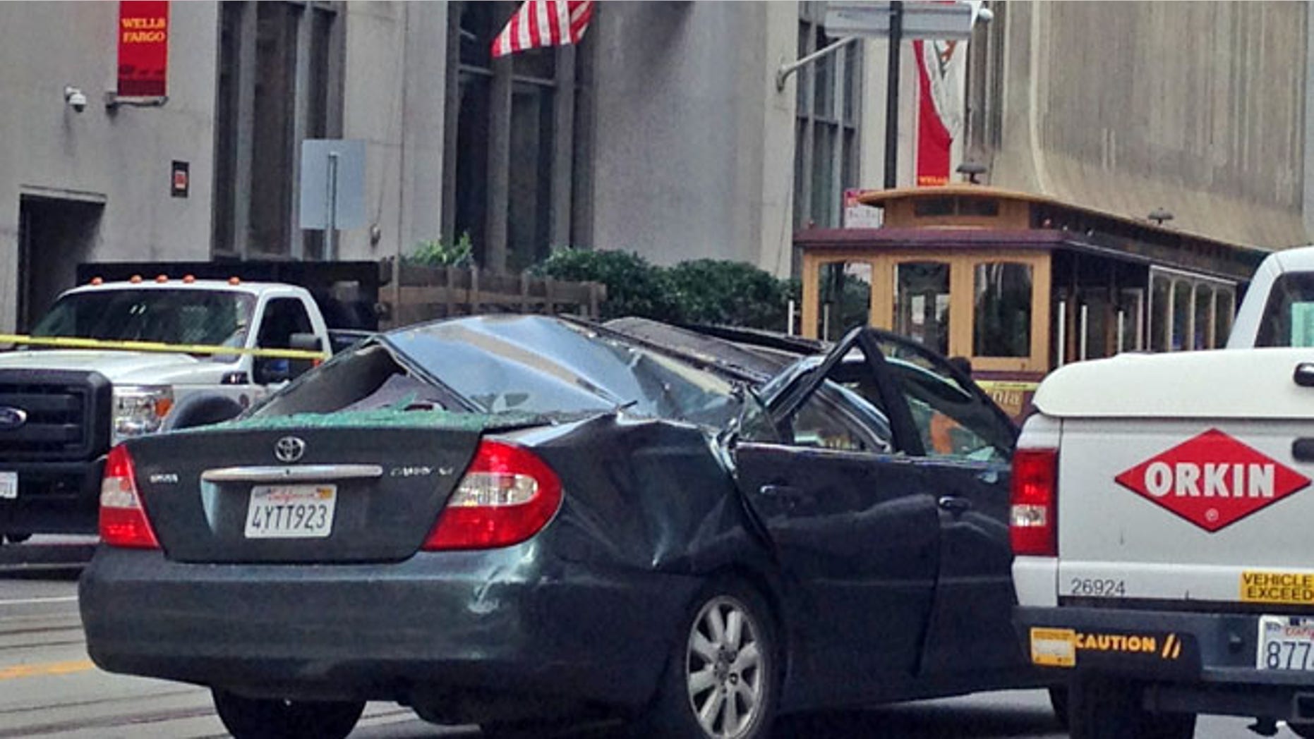 Nov. 21, 2014: A Toyota Camry has a caved in roof after a window washer fell at least 11 stories onto the moving vehicle in San Francisco. (AP)