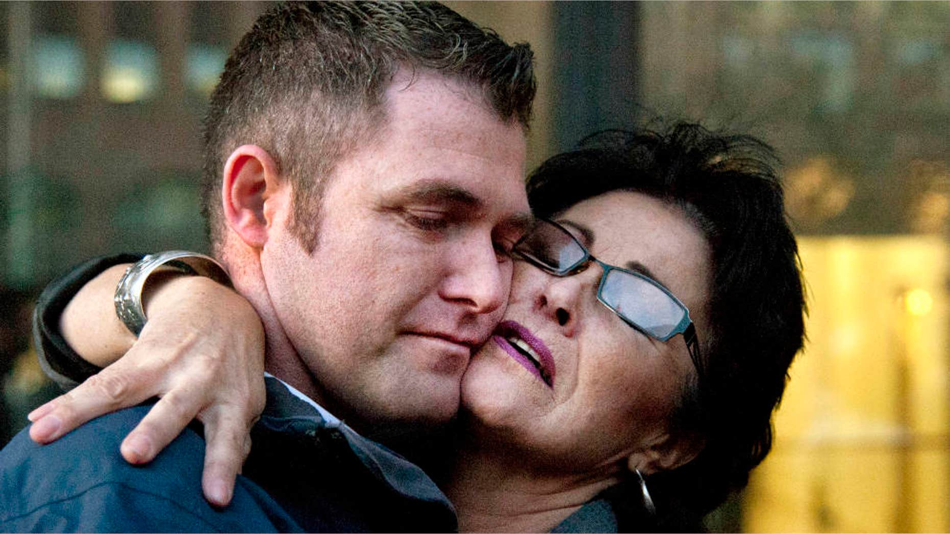 March 3, 2015: Rhonda Firestack-Harvey, right, embraces her son, Roland Gregg outside federal court.
