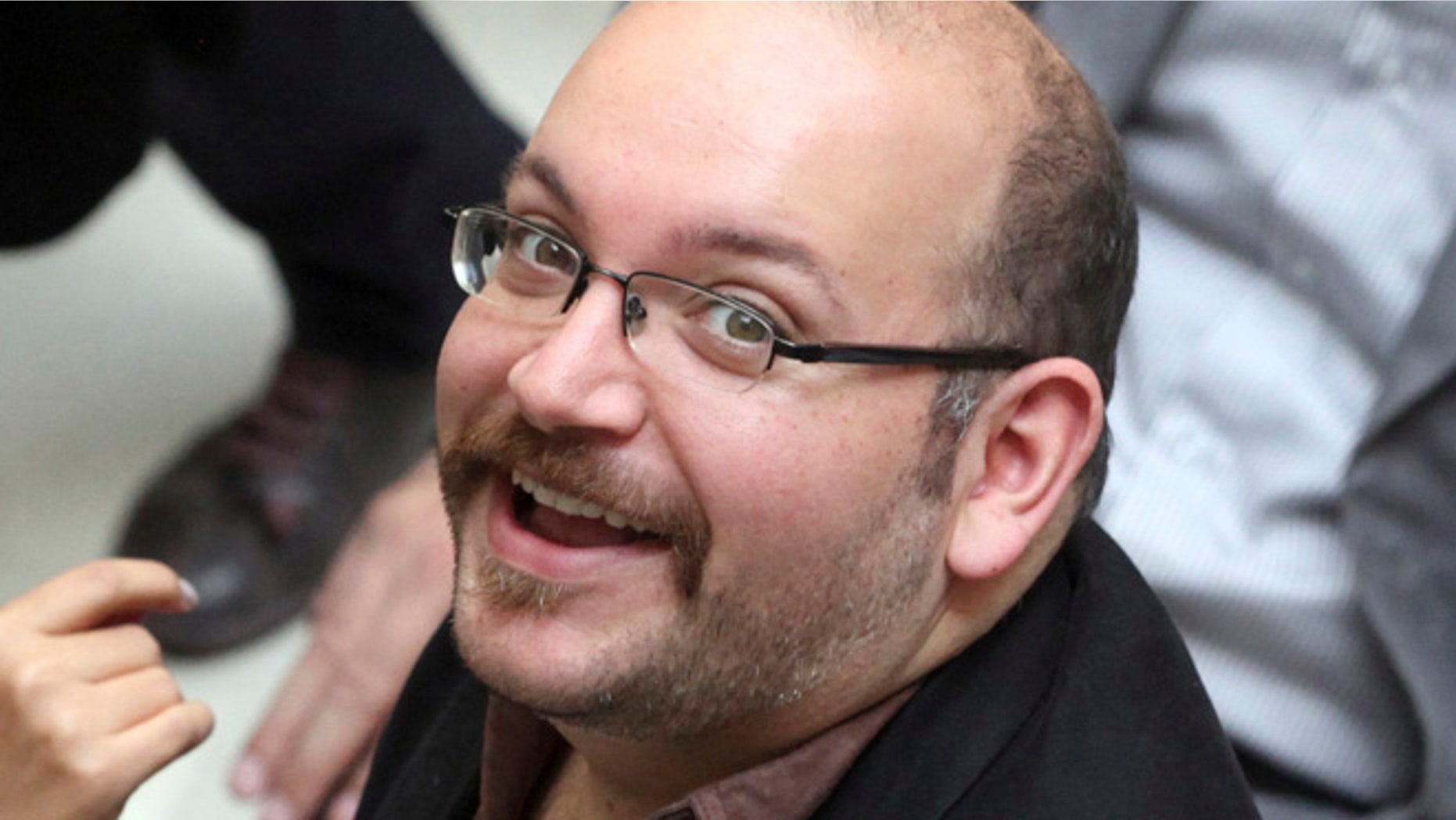FILE 2013: Jason Rezaian, an Iranian-American correspondent for the Washington Post, smiles as he attends a presidential campaign of President Hassan Rouhani in Tehran.