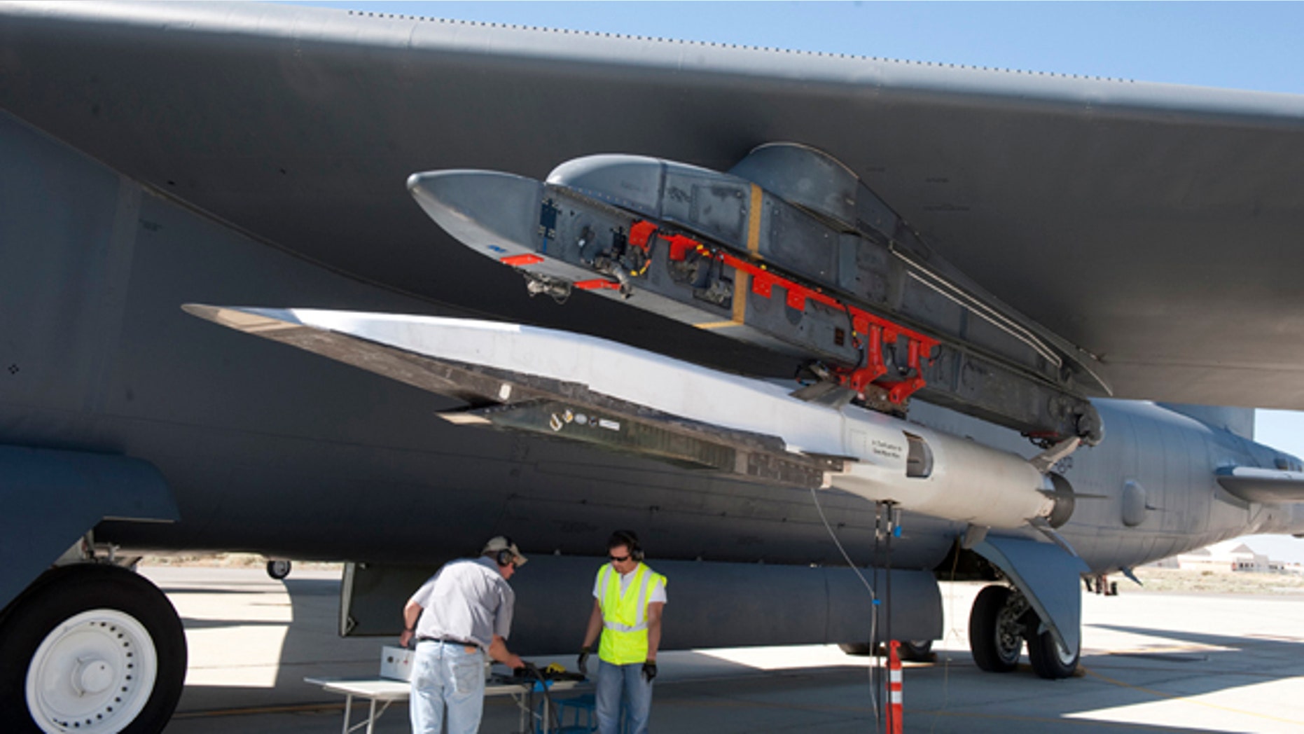Ground crew members make the final checks to the X-51A Waverider scramjet, which is affixed to an Edwards B-52H Stratofortress, before the Waverider's June 13 flight test.