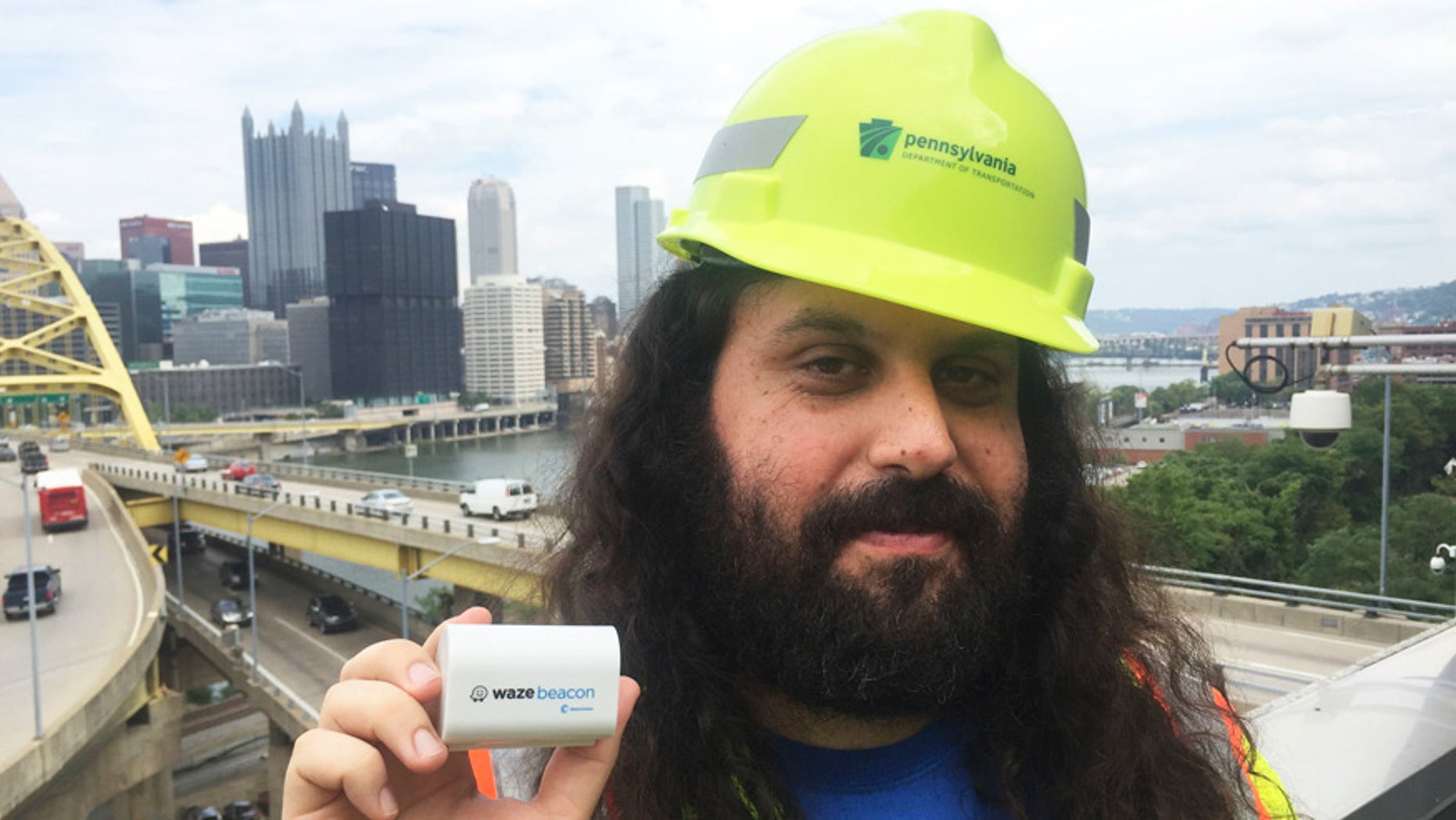 Waze system operation engineer Gil Disatnik holds a Waze beacon in Pittsburgh.