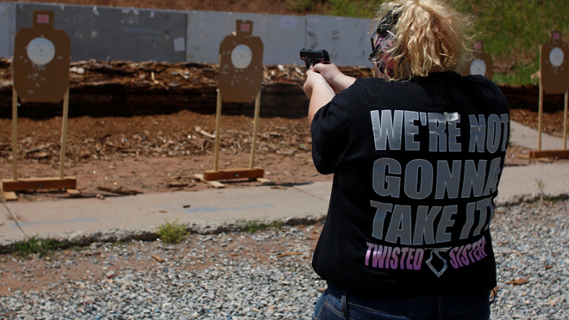 Mallory Washburn shoots at targets during a firearms training class attended by members of the Pink Pistols, a national pro-gun LGBT organization at the PMAA Gun Range in Salt Lake City, Utah