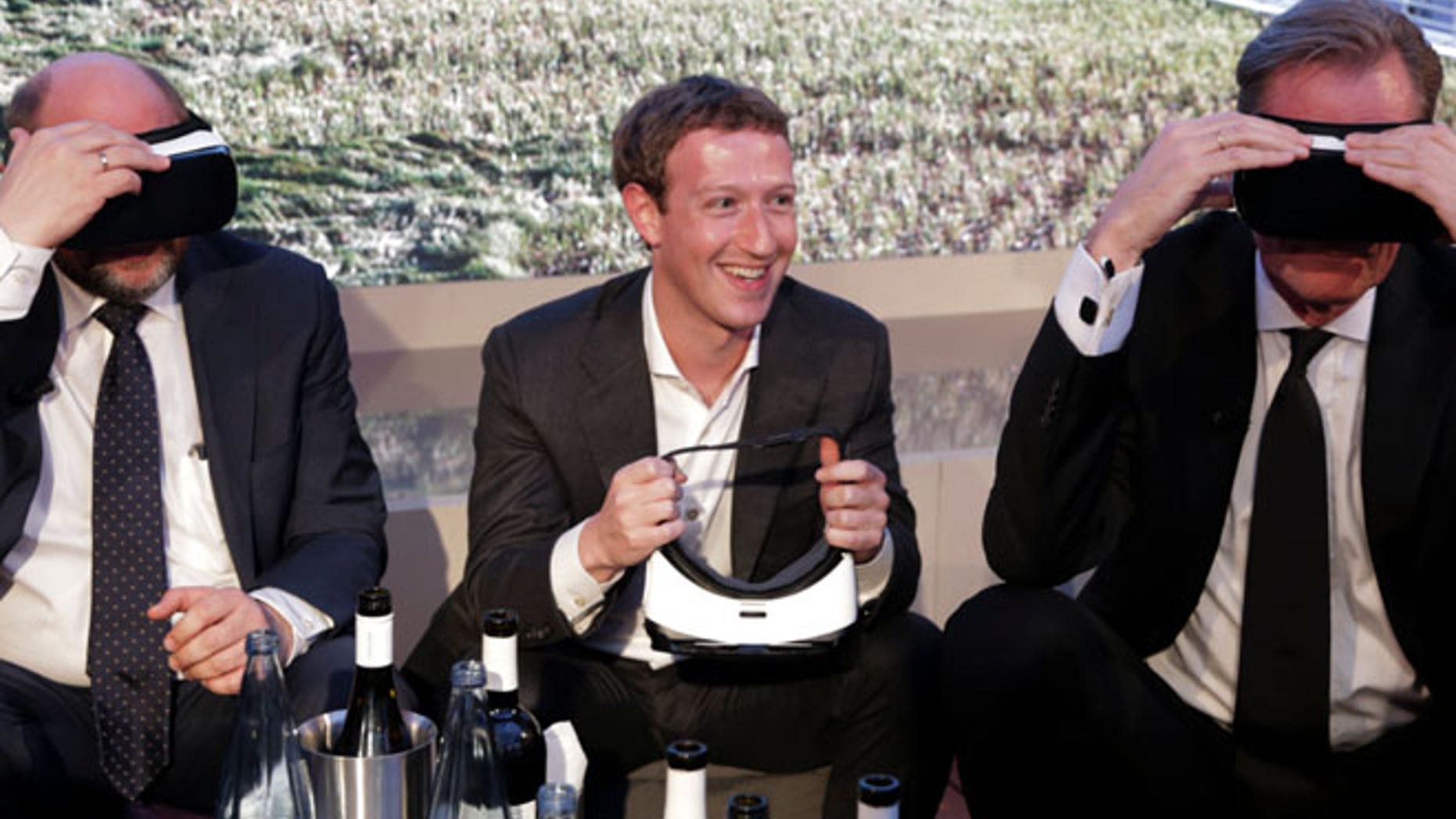 Martin Schulz, President of the European Parliament, Facebook founder and CEO Mark Zuckerberg, Mathias Doepfner, CEO of Axel Springer SE and publisher Friede Springer (L-R) try Gear VR virtual reality headsets during the awards ceremony of the newly established Axel Springer Award in Berlin