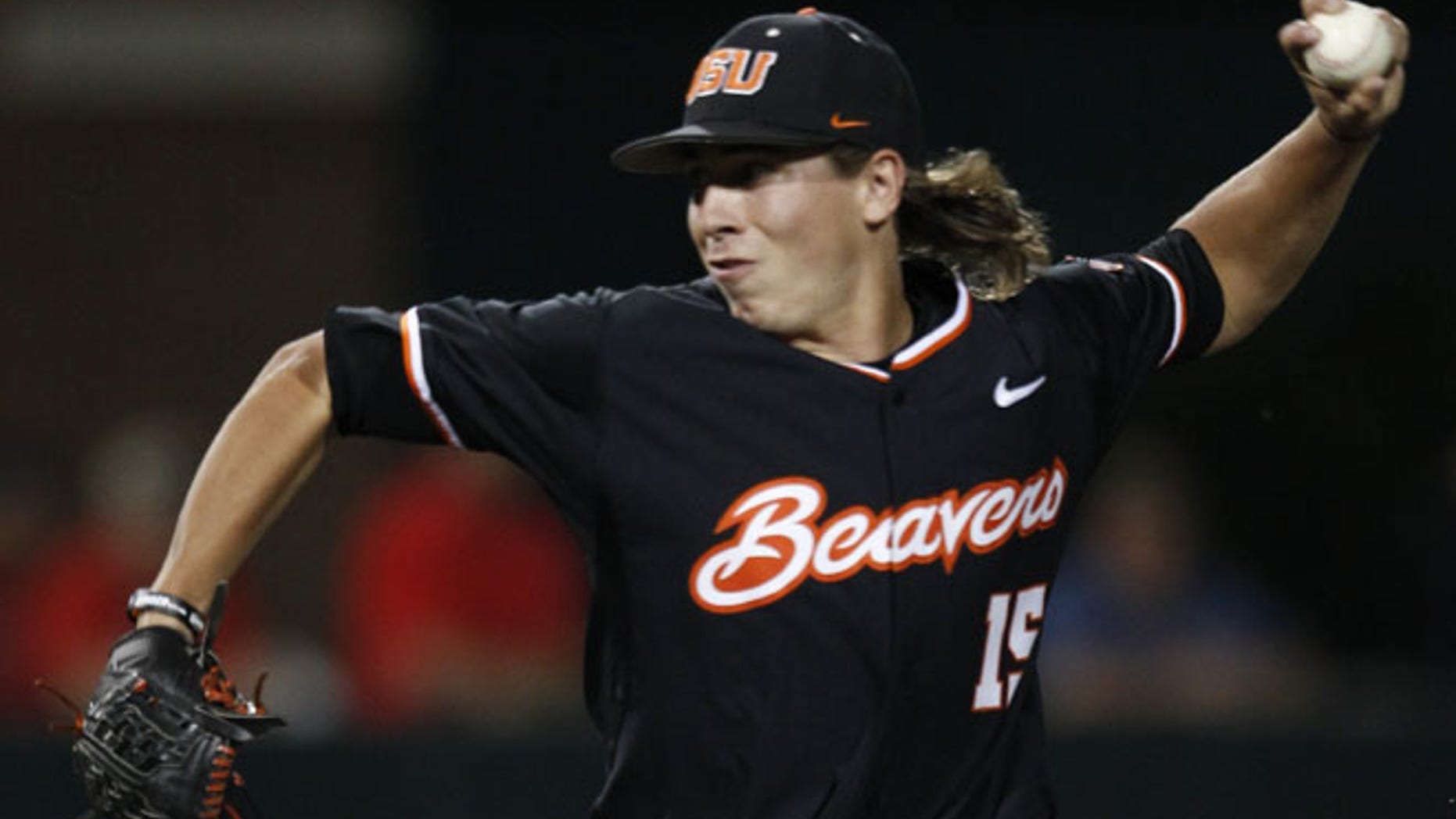 In this May 31, 2015, Oregon State's Luke Heimlich pitches to a Dallas Baptist batter during the third inning of an NCAA college baseball tournament regional game in Dallas, Texas.