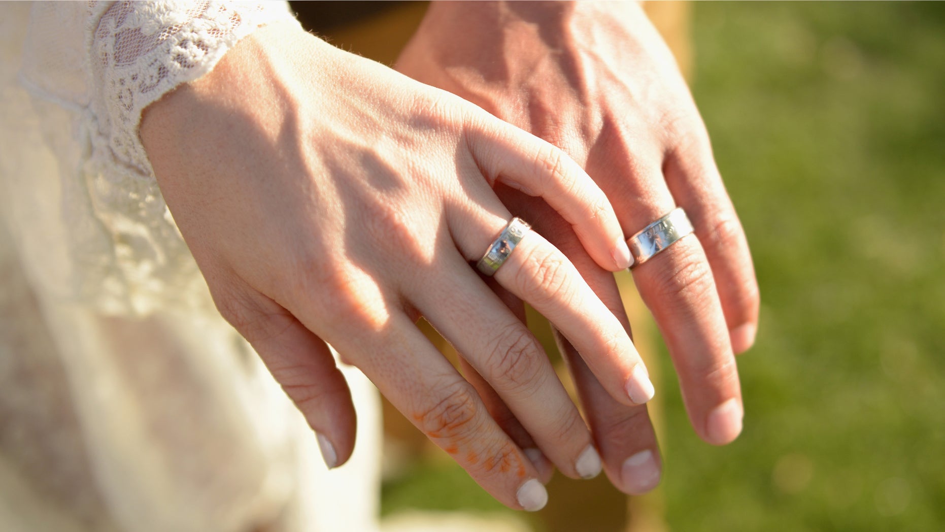 The hands of bride and groom are seen in Indio, California, April 11, 2015.