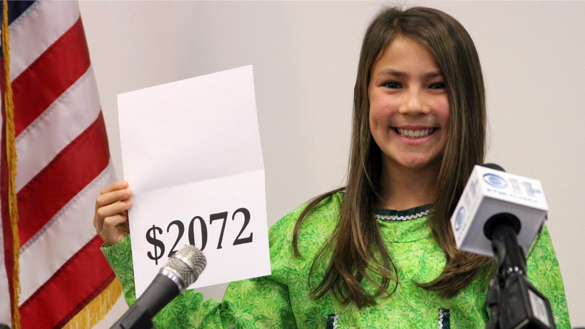 FILE 2015: Student Shania Sommer of Palmer, Alaska, announces that nearly every Alaskan will receive $2,072 from the year's oil dividend check during a news conference in Anchorage, Alaska.