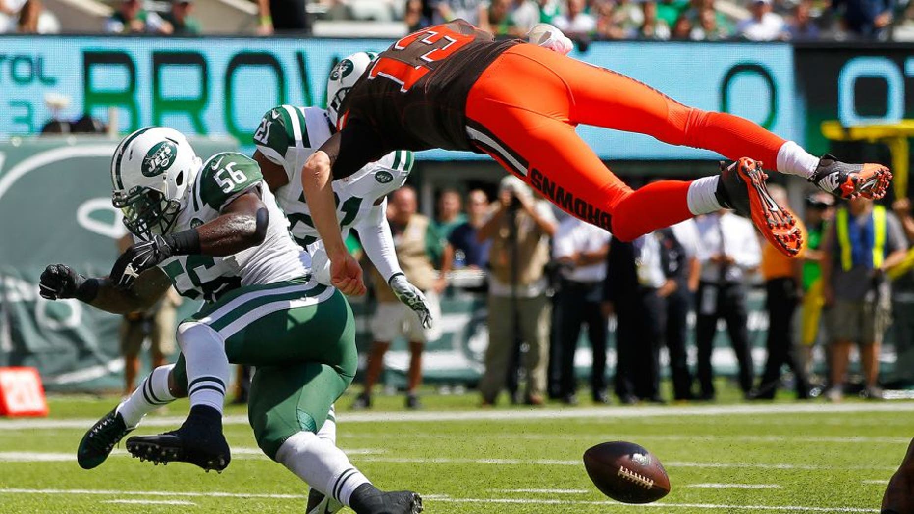 EAST RUTHERFORD, NJ - SEPTEMBER 13: Quarterback Josh McCown #13 of the Cleveland Browns fumbles at the goal line after being hit by Demario Davis #56 of the New York Jets during the first quarter at MetLife Stadium on September 13, 2015 in East Rutherford, New Jersey. The Jets won 31-10. (Photo by Rich Schultz /Getty Images)