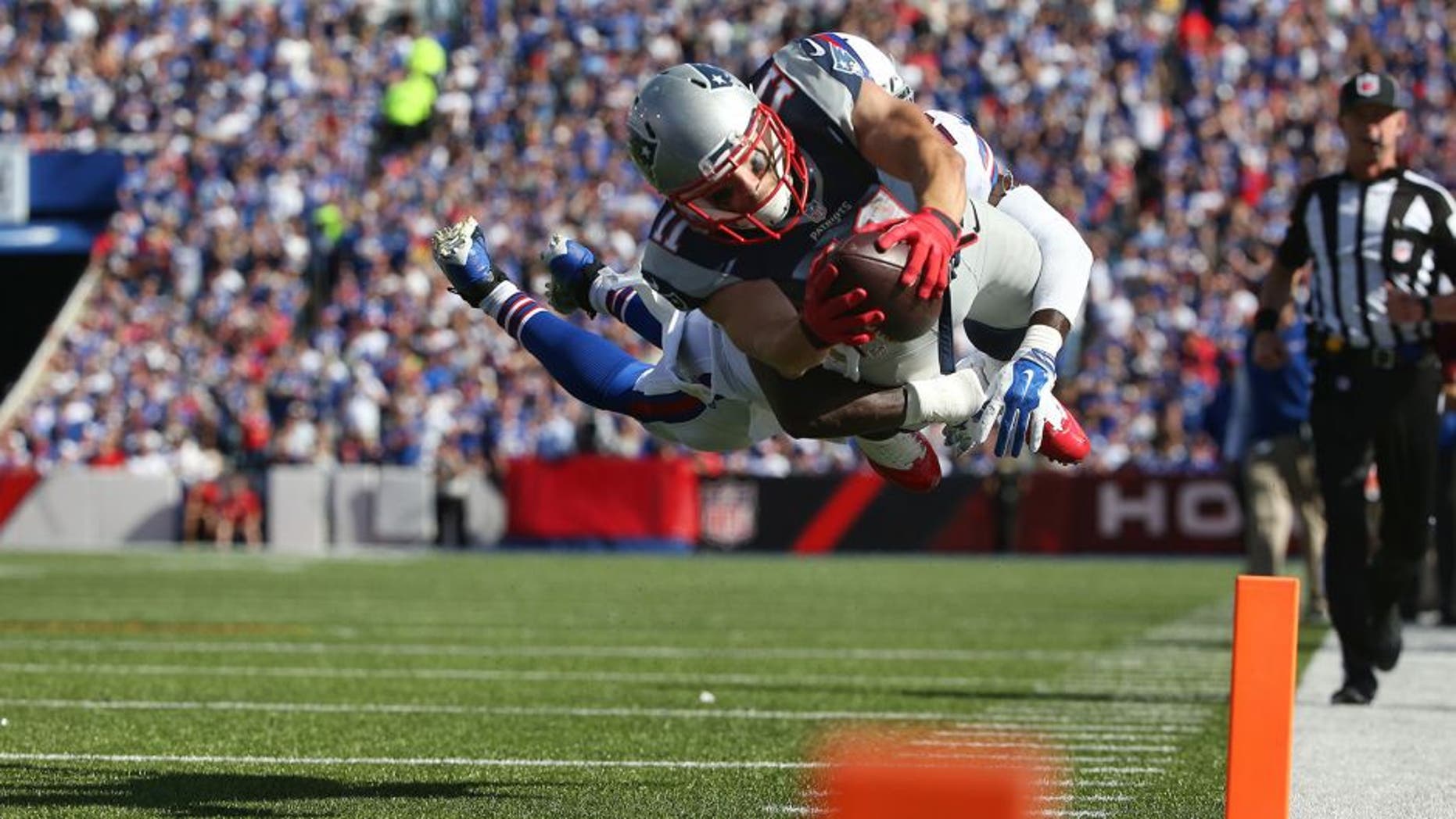 ORCHARD PARK, NY - SEPTEMBER 20: Julian Edelman #11 of the New England Patriots scores a touchdown during NFL game action as Aaron Williams #23 of the Buffalo Bills tries to make the tackle at Ralph Wilson Stadium on September 20, 2015 in Orchard Park, New York. (Photo by Tom Szczerbowski/Getty Images)