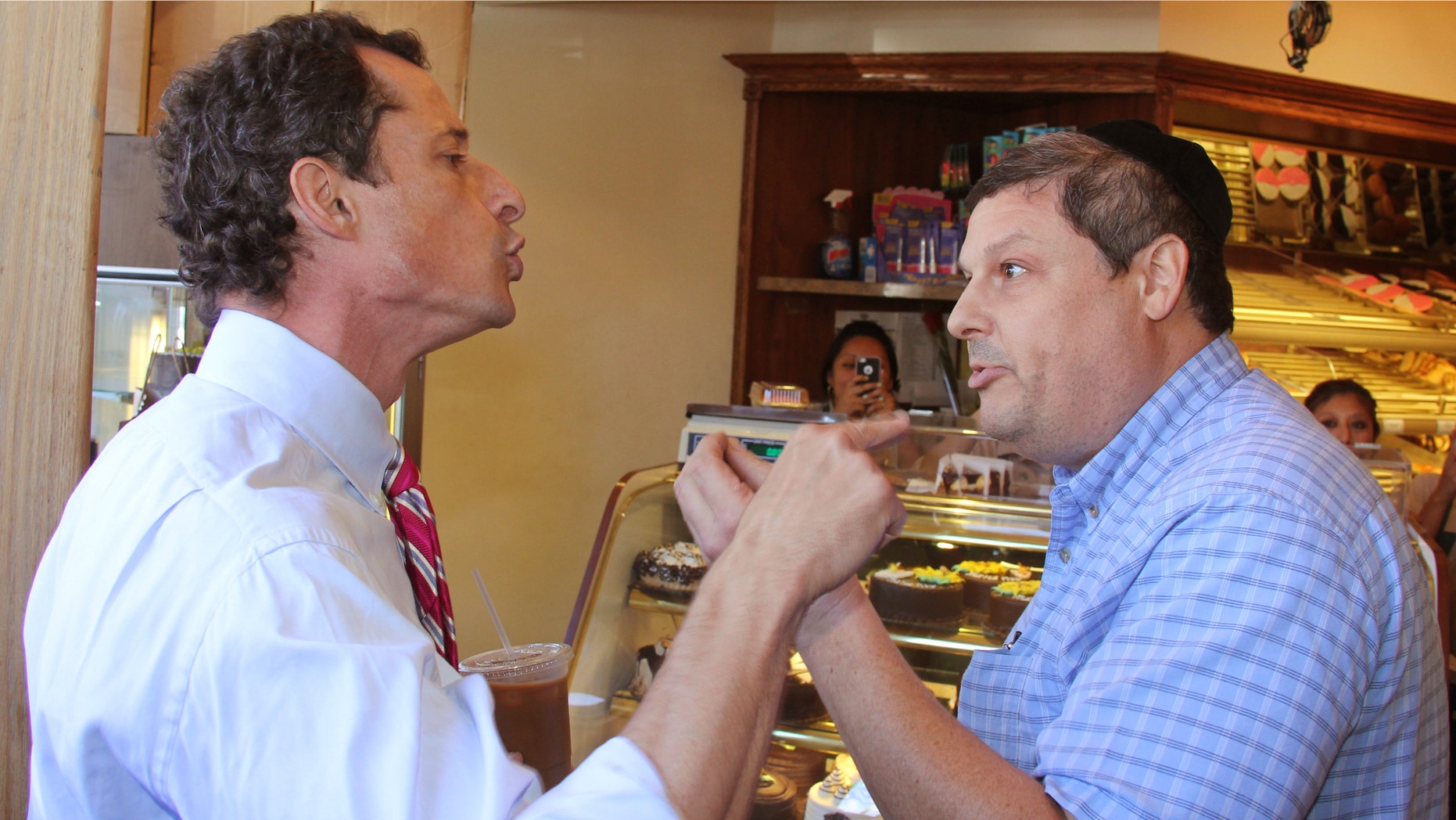 Anthony Weiner, left, who is seeking the Democratic nomination to run for the New York City Mayors Office, has a heated argument with Shaul Kessler at Weiss Bakery in the Boro Park neighborhood in the Brooklyn borough of New York, Wednesday, Sept. 4, 2013.