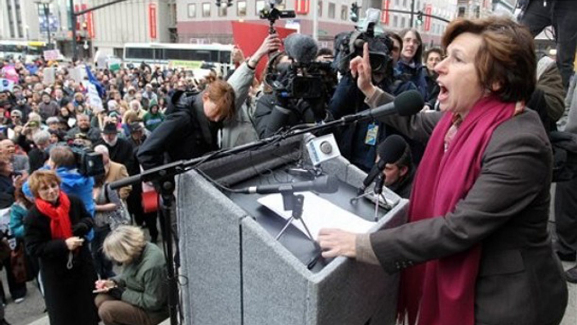 Randi Weingarten, right, president of the American Federation of Teachers, speaks to a crowd on the steps of Providence, R.I., City Hall March 2.