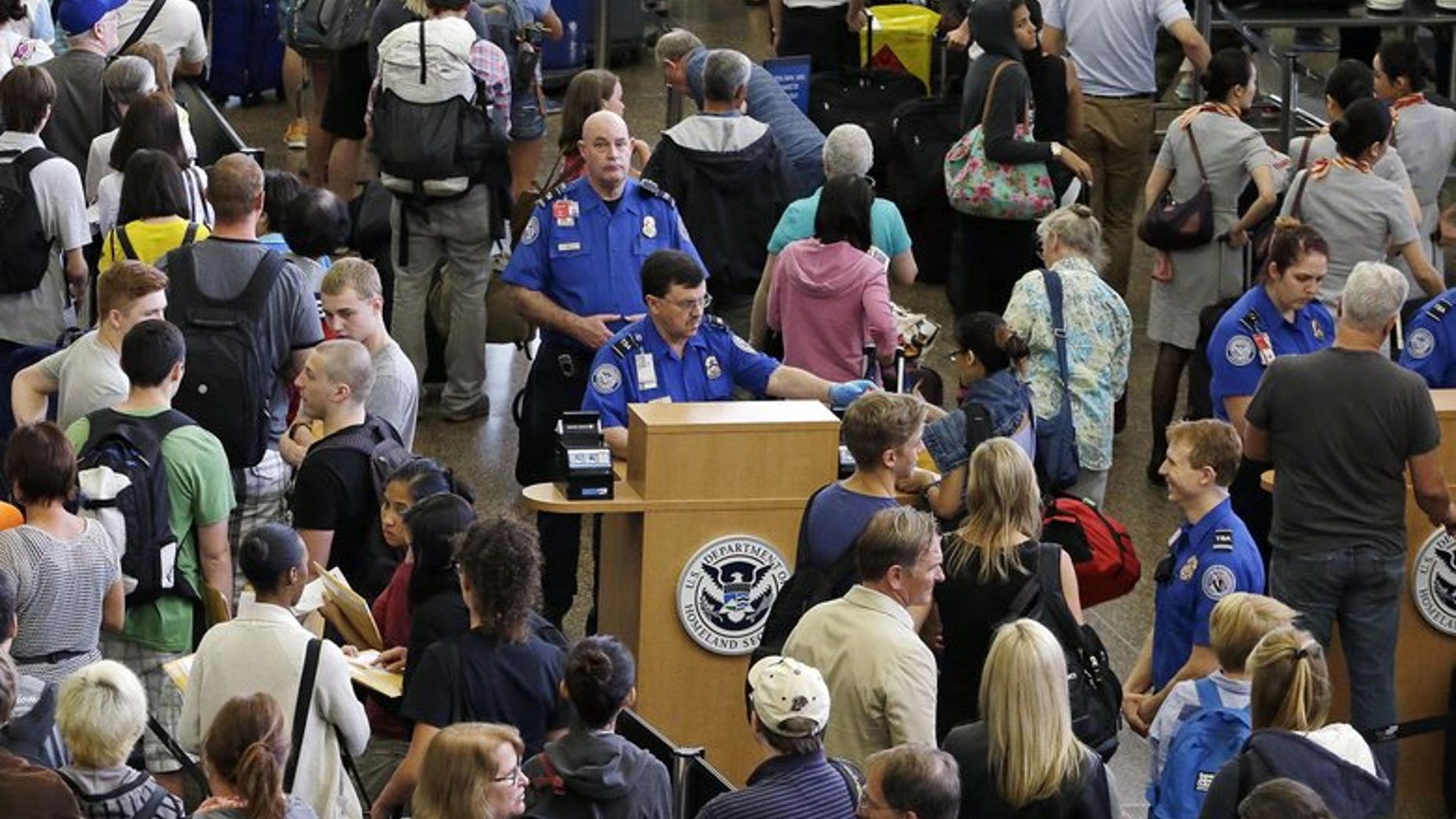 Travelers at Seattle-Tacoma International Airport wait to go through TSA security.