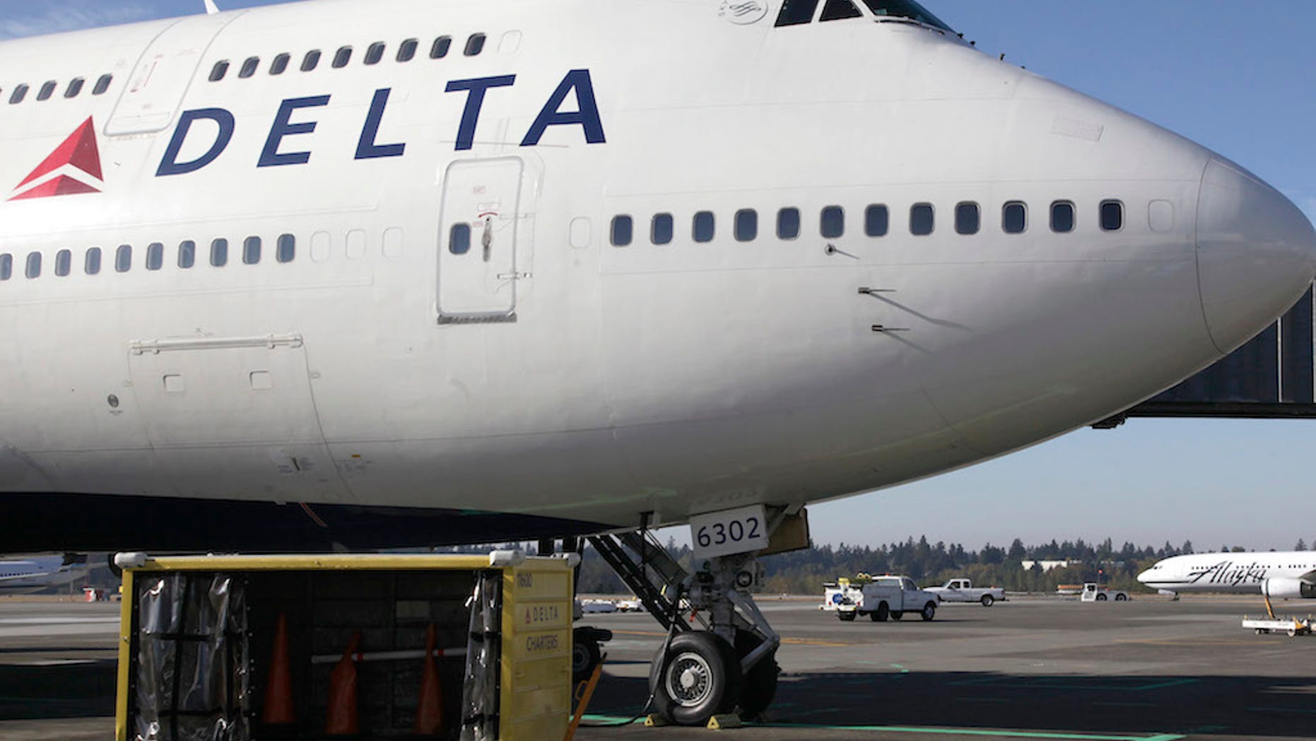 FILE - In this Oct. 8, 2012 file photo, a Delta Air Lines airplane is parked at Seattle-Tacoma International Airport in Seattle. Delta reports quarterly earnings on Wednesday, April 23, 2014. (AP Photo/Ted S. Warren File)