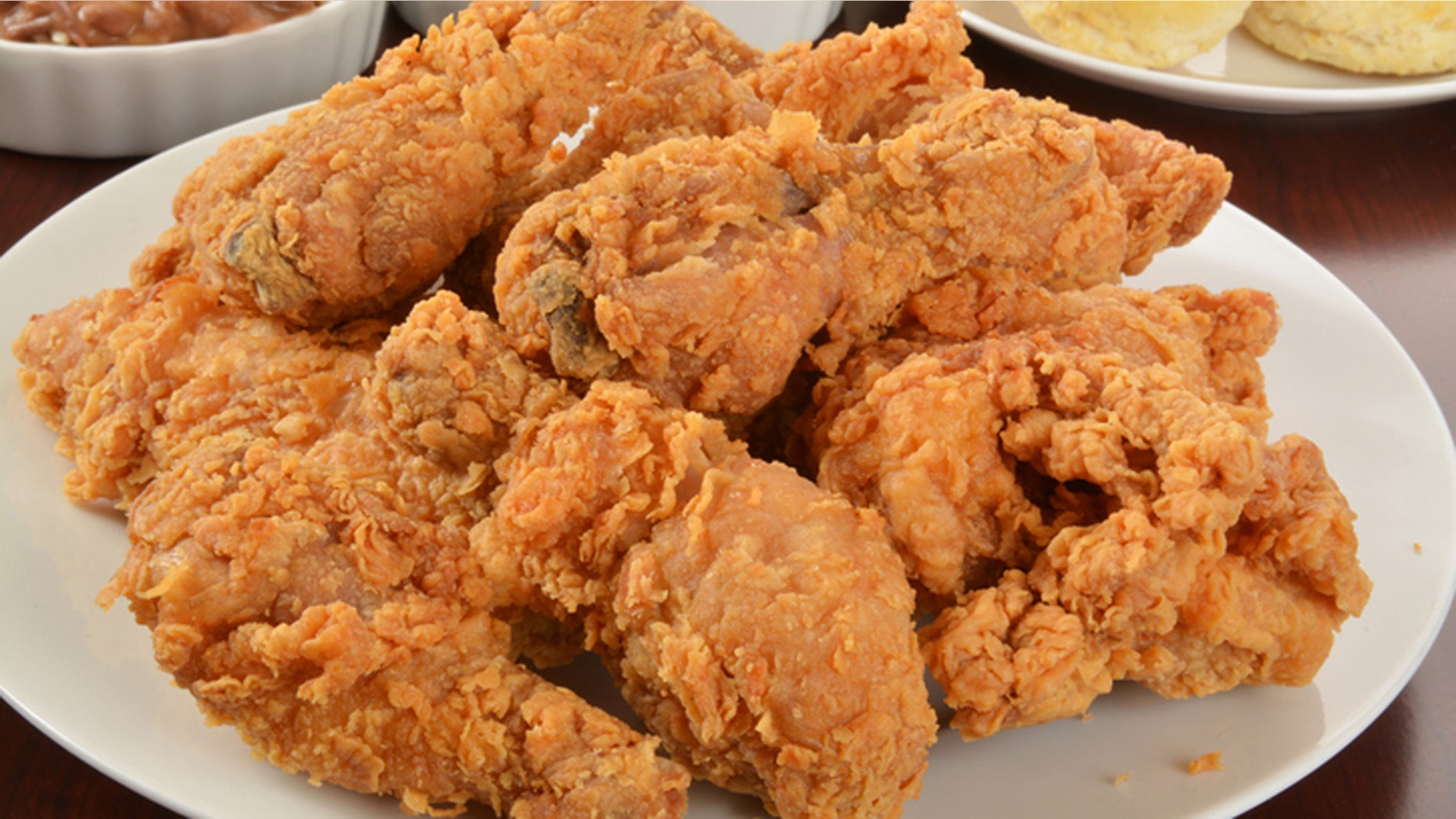 A plate of fried chicken with side dishes