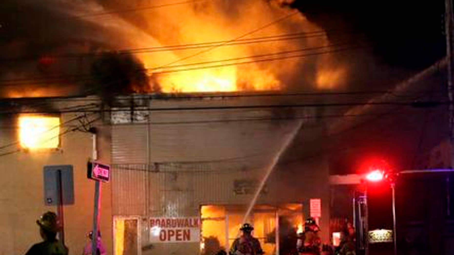 In this Thursday, Sept. 12, 2013, file photograph, firefighters battle a blaze in a building along the Seaside Park boardwalk in Seaside Park, N.J. The historic Jersey shore pier that was pummelled by Superstorm Sandy, then destroyed in a spectacular fire may finally be done in by building regulations. The owner of the former Funtown Pier in Seaside Park, said he won't rebuild it if the town sticks to height restrictions it wants to impose on rides on a rebuilt pier.