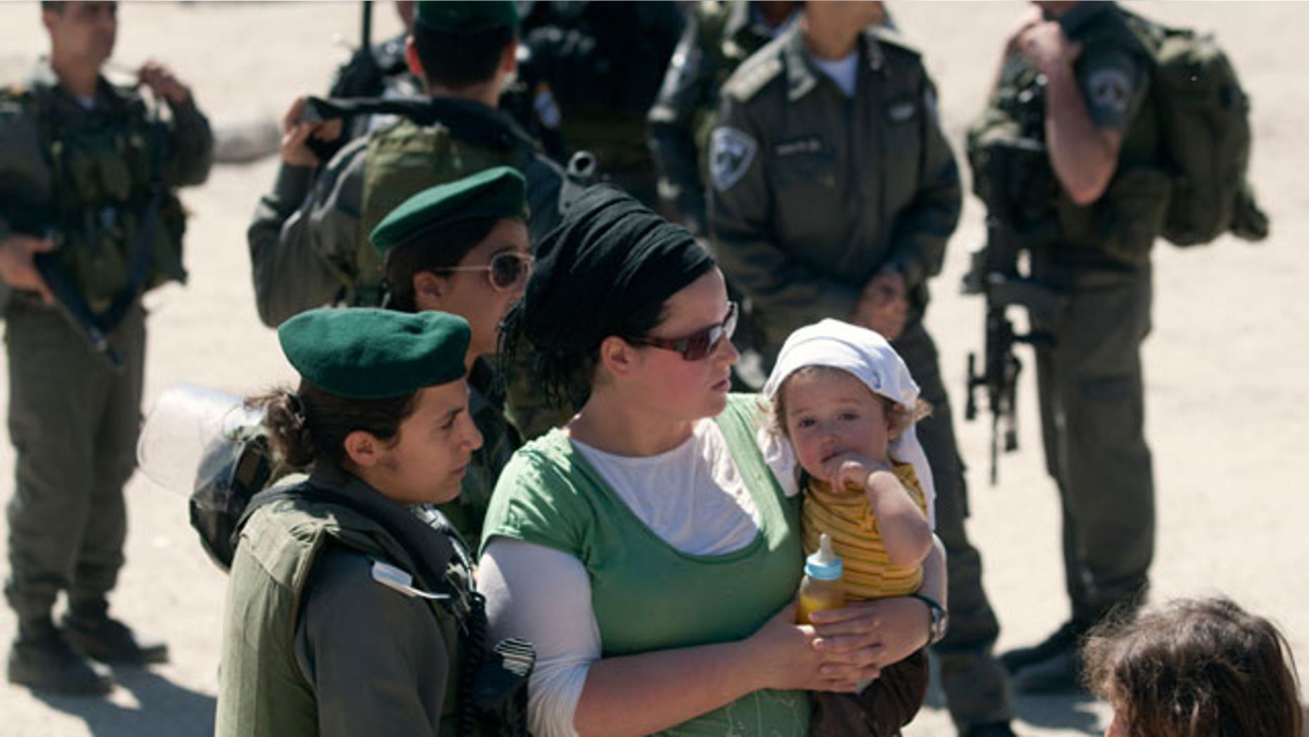 Apr. 4, 2012: A Jewish settler is stopped at a checkpoint manned by Israeli border police near a house illegally occupied by settlers in the West Bank city of Hebron.