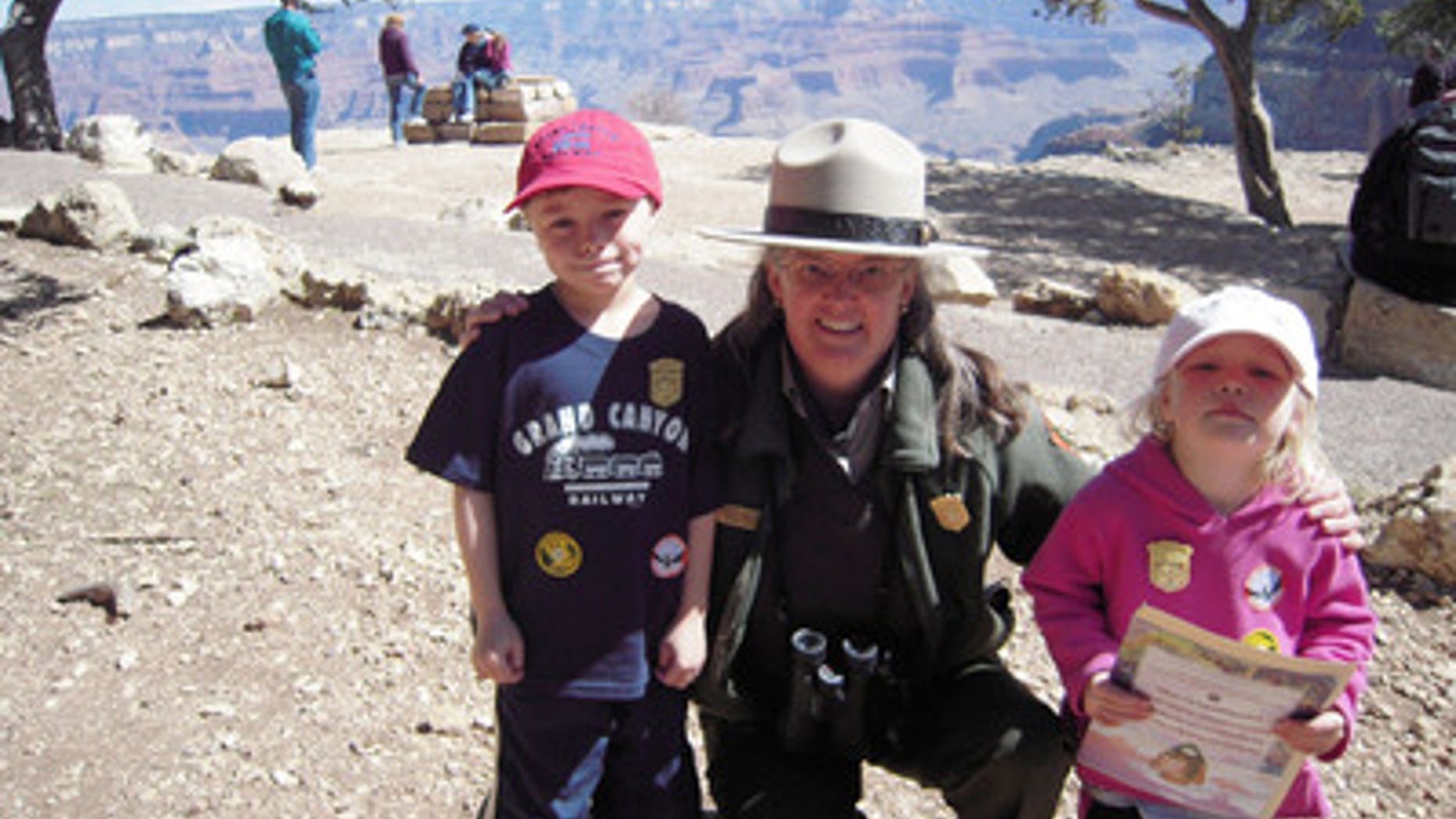 Ethan Sitzman and his sister Hannah with a park ranger at Grand Canyon. Part of the Junior Ranger program.