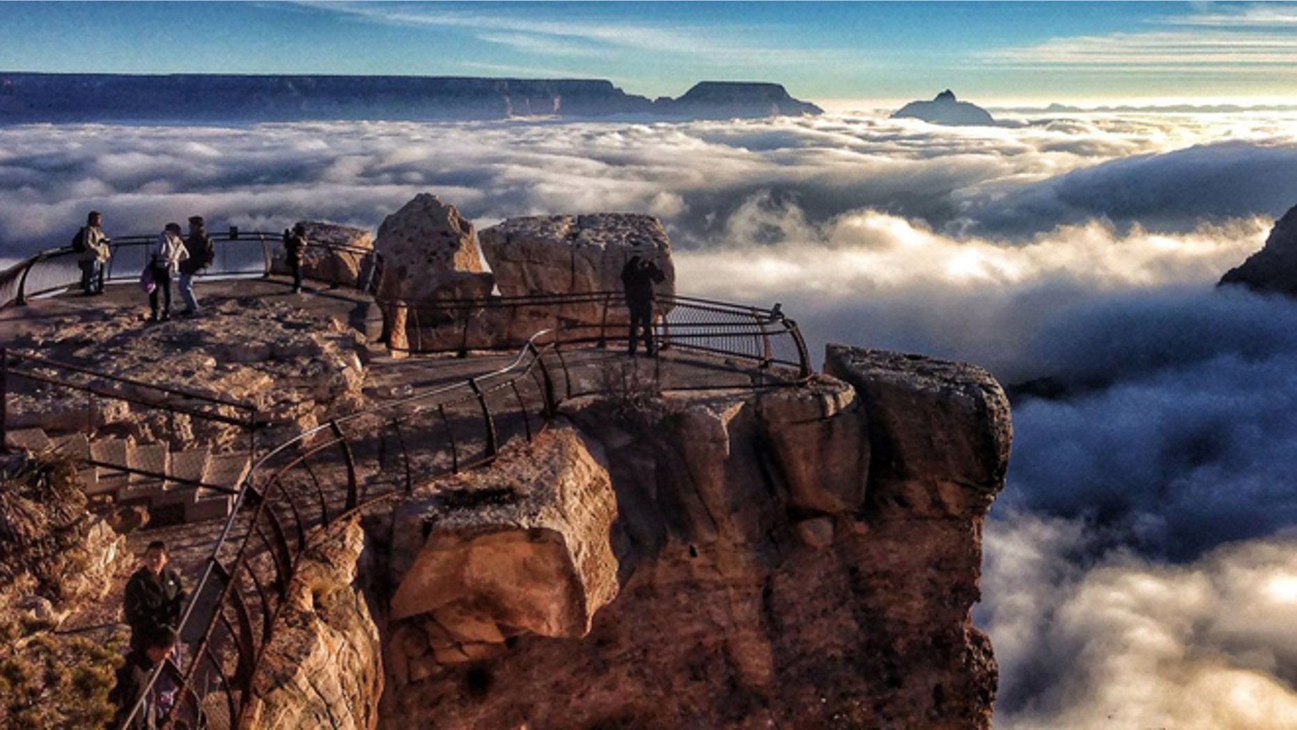 Visitors to Mather Point at Grand Canyon National Park, Ariz. look out over a rare total cloud inversion in 2013.