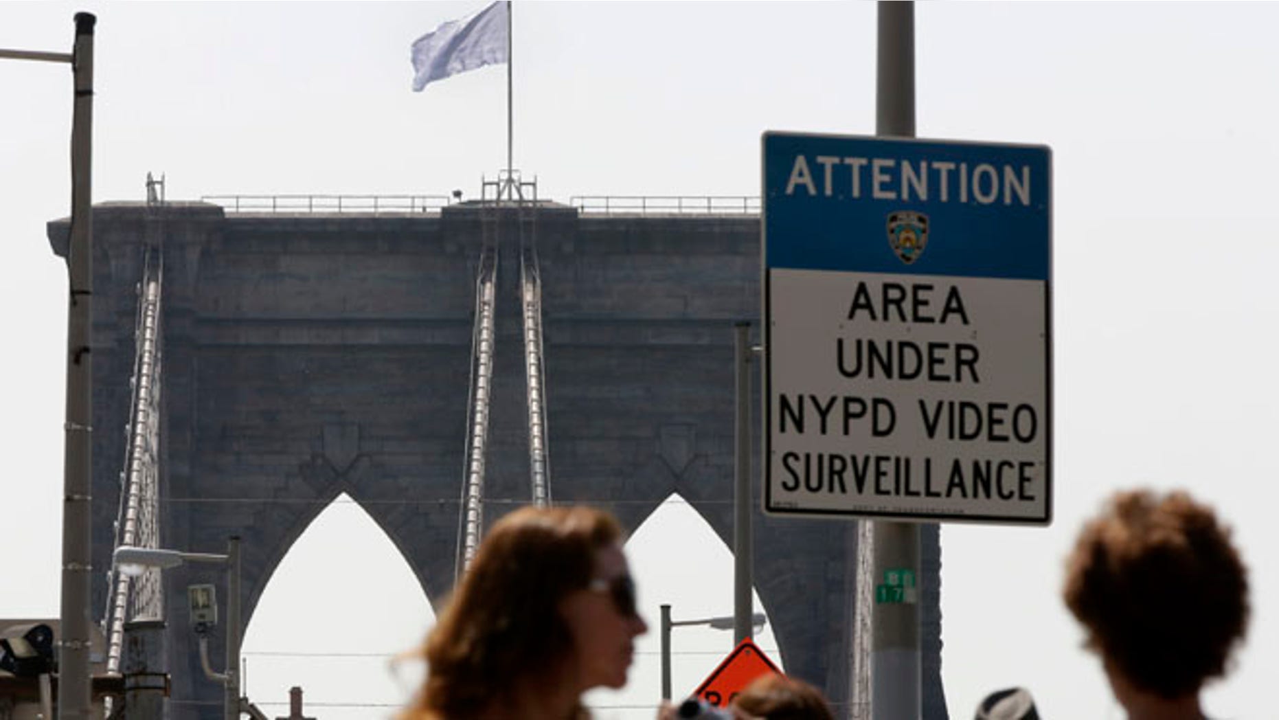 July 22, 2014: A white flag flies atop the west tower of New York's Brooklyn Bridge. The NYPD is investigating who was behind the flag switch, but one person called The Daily News claiming responsibility.