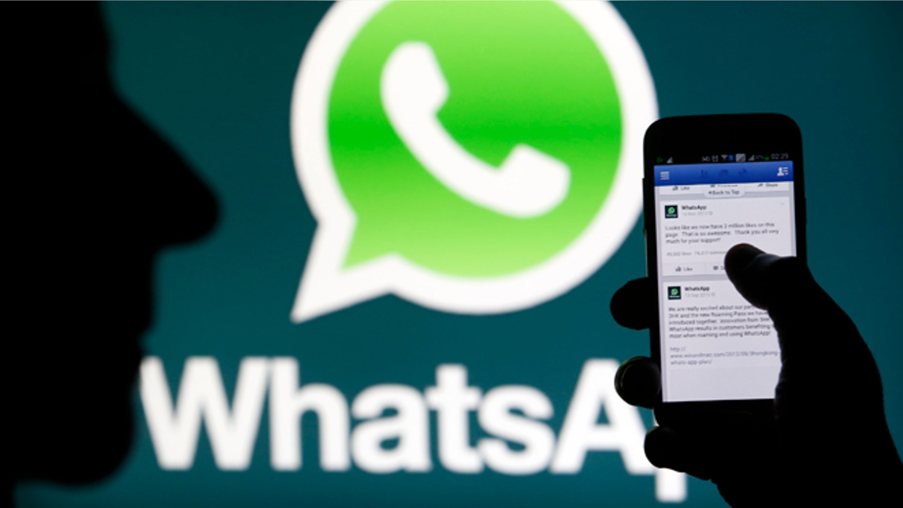 A Whatsapp App logo is seen behind a Samsung Galaxy S4 phone that is logged on to Facebook. Facebook Inc will buy fast-growing mobile-messaging startup WhatsApp for $19 billion in cash and stock in a landmark deal that places the world's largest social network closer to the heart of mobile communications and may bring younger users into the fold.